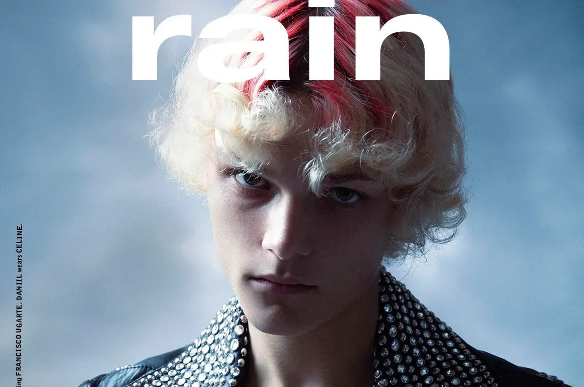 Cover of Rain Magazine featuring a model in a studded Celine Homme leather jacket with a red streak in his blonde hair, embodying the theme of 'Renaissance'.