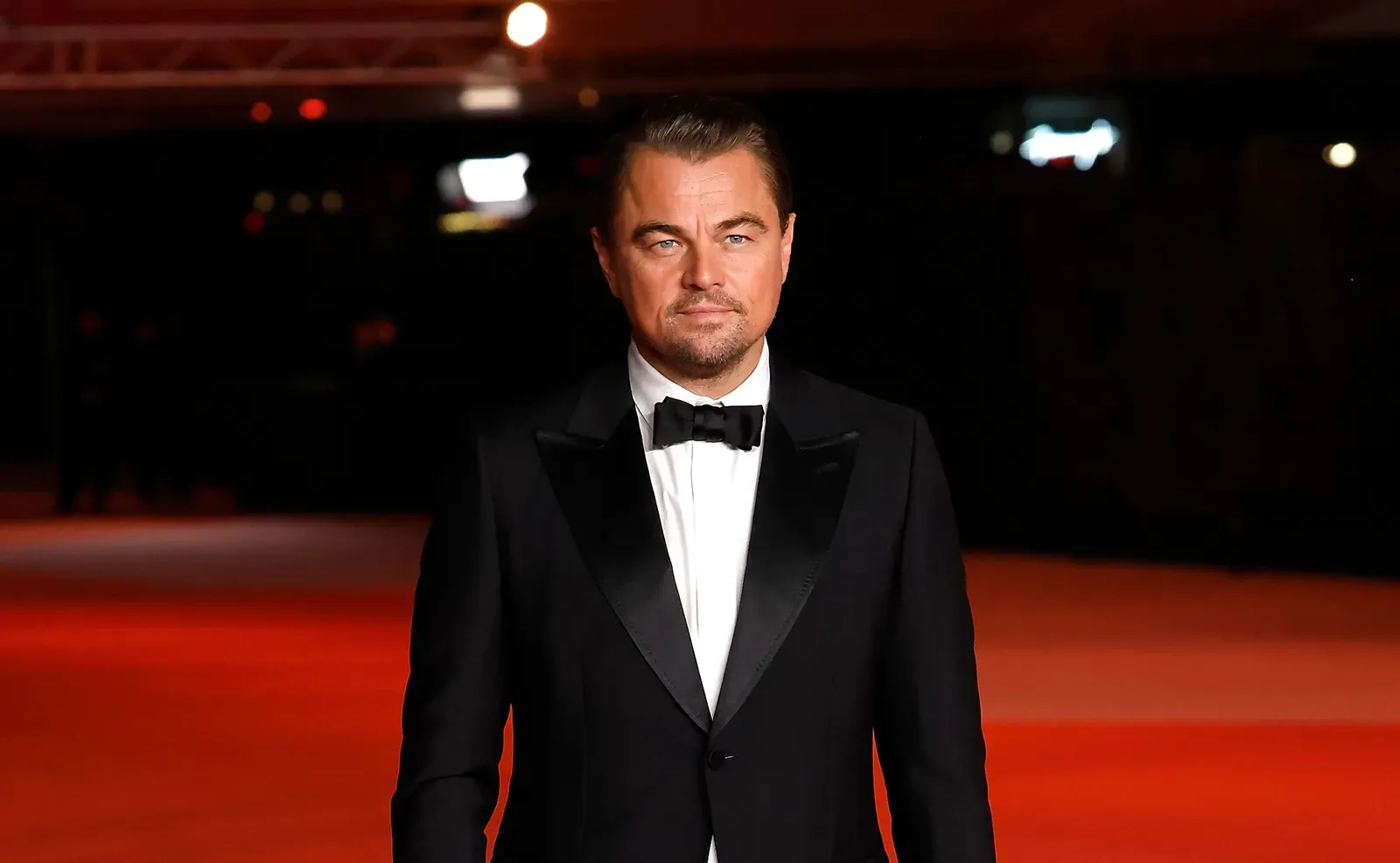 Leonardo DiCaprio in a classic tuxedo at the Academy Museum Gala in Los Angeles, exemplifying traditional Hollywood elegance.