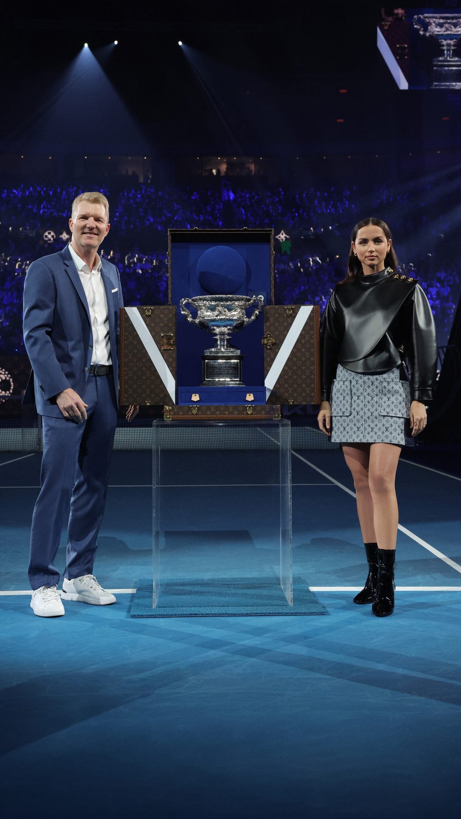 Ana de Armas and Jim Courier unveiled the prestigious Norman Brookes Challenge Cup, encased in a Louis Vuitton Trophy Trunk, during the Men's Final at the Australian Open.