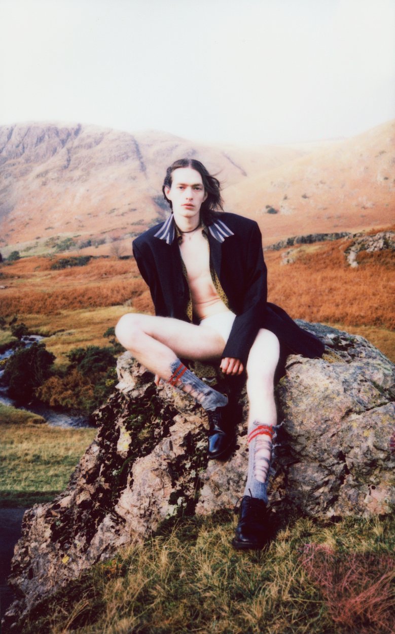 Jacket and shirt by BALENCIAGA, underwear by TOM FORD, socks by MAISON MARGIELA, shoes by CHURCH’S x VETEMENTS, necklace’s ERIK’S OWN
