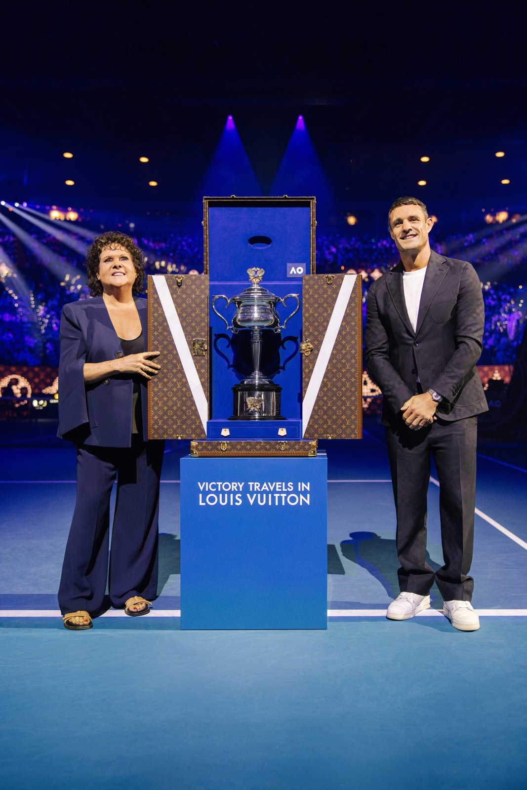 Tennis legend Evonne Goolagong Cawley and Louis Vuitton House Ambassador Dan Carter present the Daphne Akhurst Memorial Cup in its custom Louis Vuitton trunk at the 2025 Australian Open Women's Final (Photo: Courtesy of Louis Vuitton)