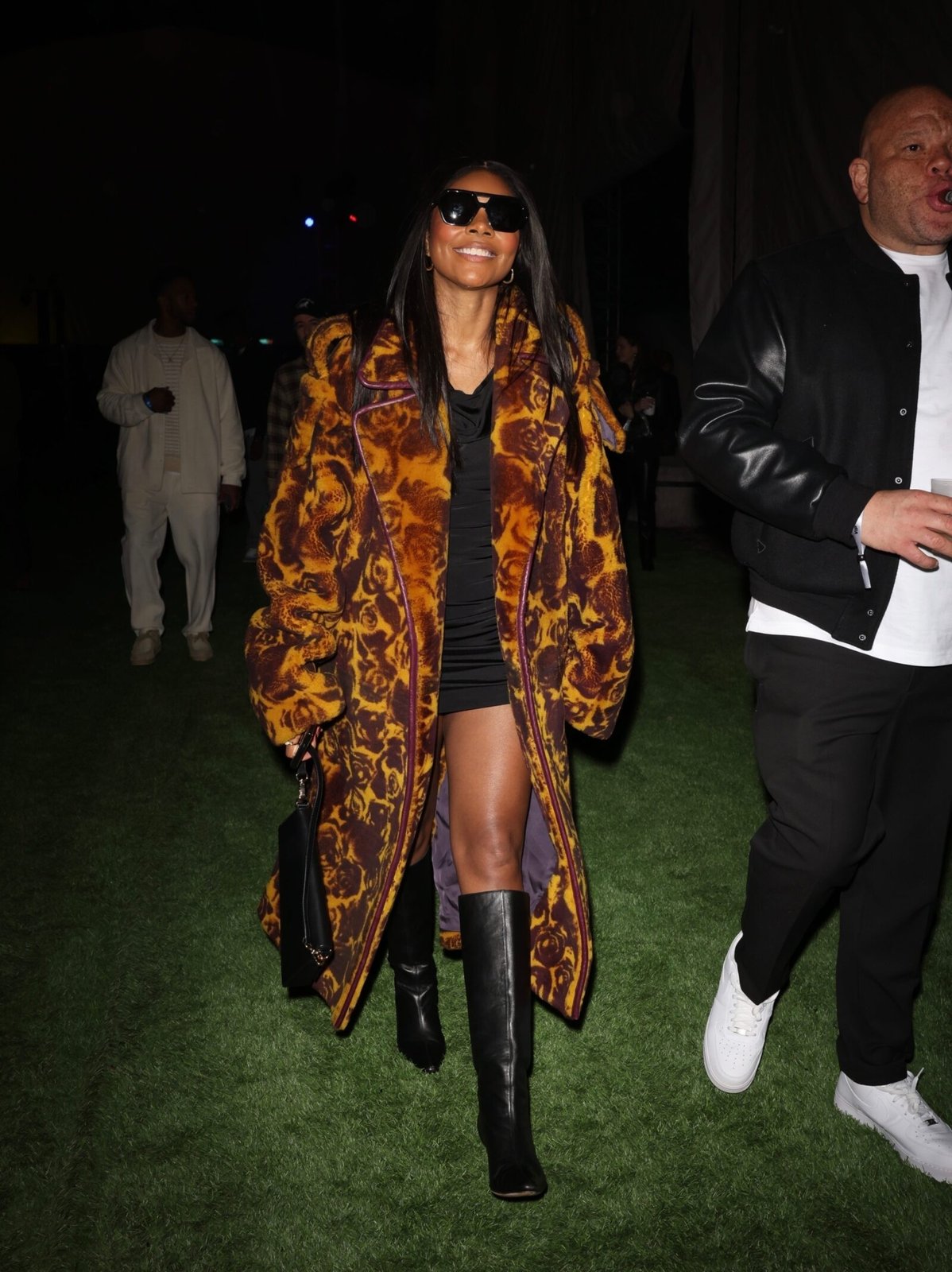 Las Vegas, NV - Gabrielle Union dazzles in a Burberry trench featuring a luxurious baroque rose print set against sumptuous shearling, epitomizing elegance. (Photo credit: Backgrid)
