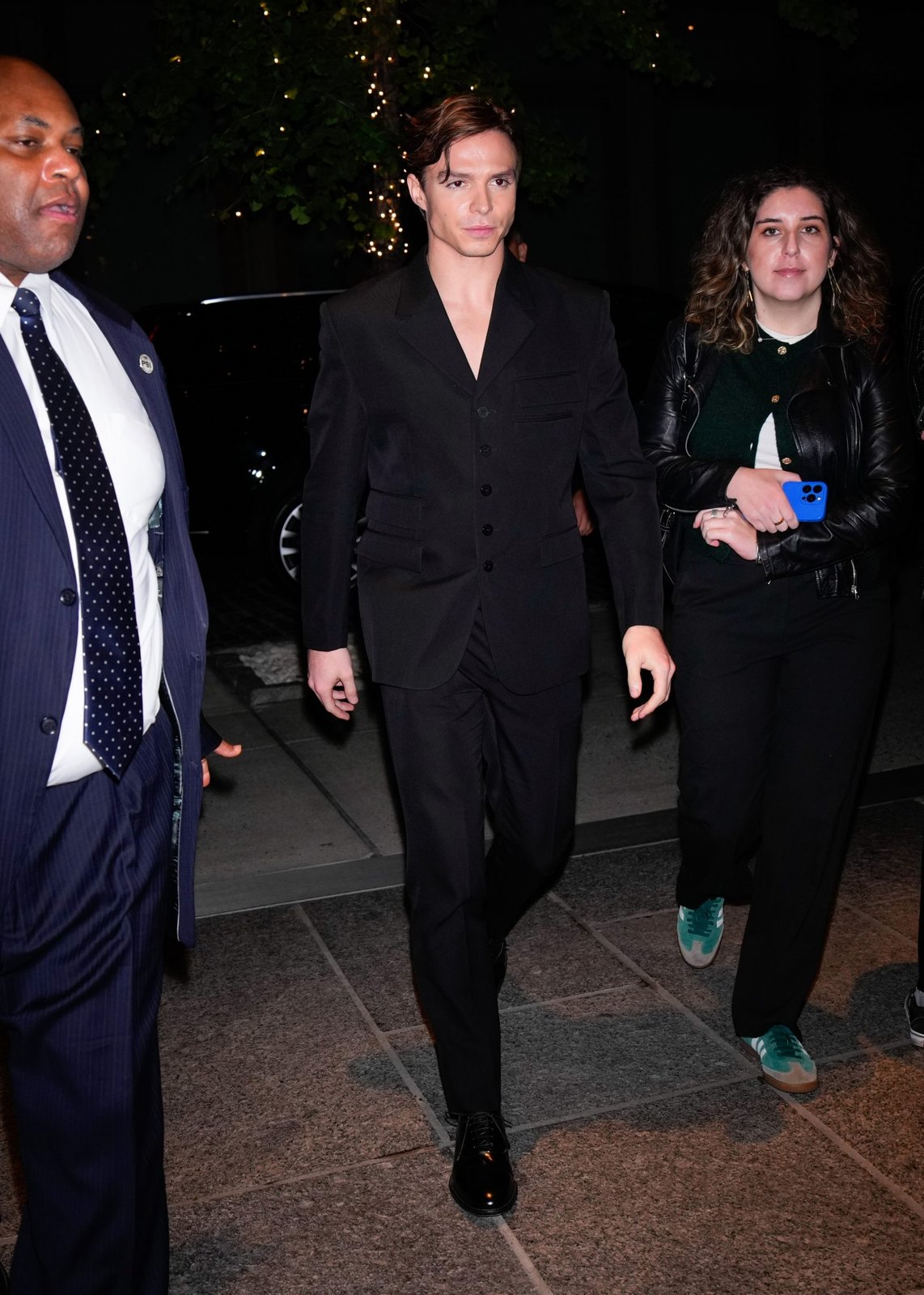 Actor Nicholas Alexander Chavez showcases Versace's refined tailoring in a sharp black wool grain de poudre suit from the Fall-Winter 2024 collection at the NYC screening of Monsters: The Lyle and Erik Menendez Story.