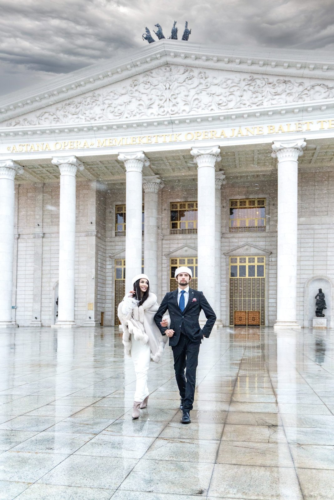 Photographed at Astana Opera House, Jesse wears bespoke wool suit; silk tie, MISSONI; leather oxfords, ERMENEGILDO ZEGNA; felt hat, MO&SA KAZAKHSTAN. Gigi wears silk dress, MALLI; leather boots, ANARA YERIKOVNA; felt hat, MO&SA KAZAKHSTAN.
