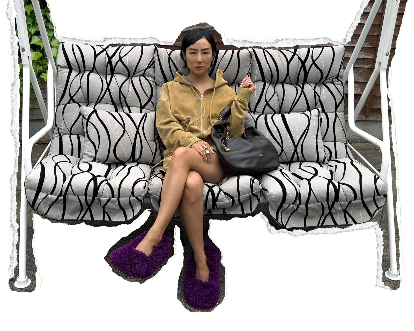 Greta Lee embodies comfort and artistry with a LOEWE handbag in hand.