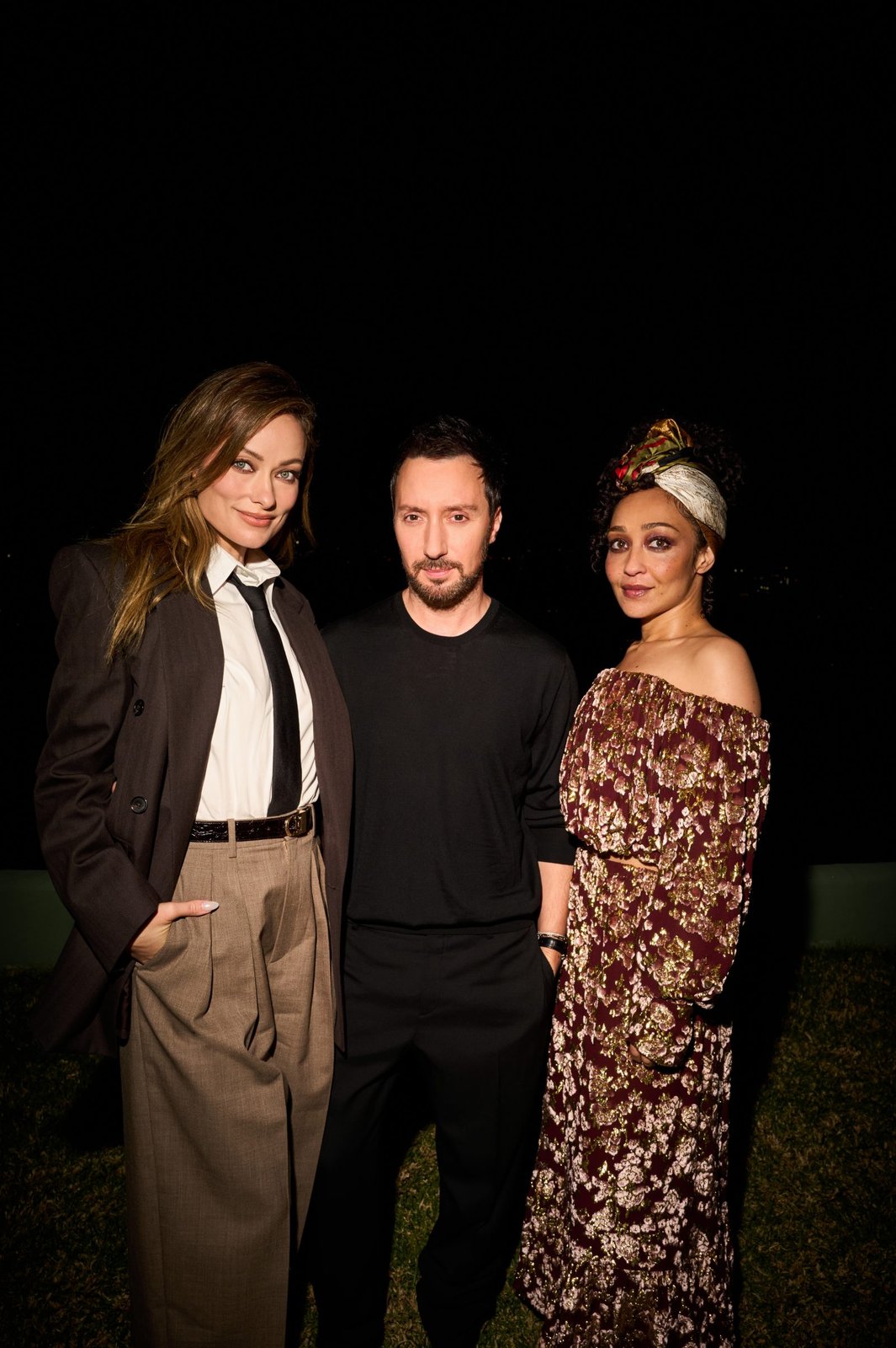 Olivia Wilde, Anthony Vaccarello, and Ruth Negga pose together at the Saint Laurent x Vanity Fair pre-Oscar dinner in Hollywood Hills. (Photo courtesy of Saint Laurent)
