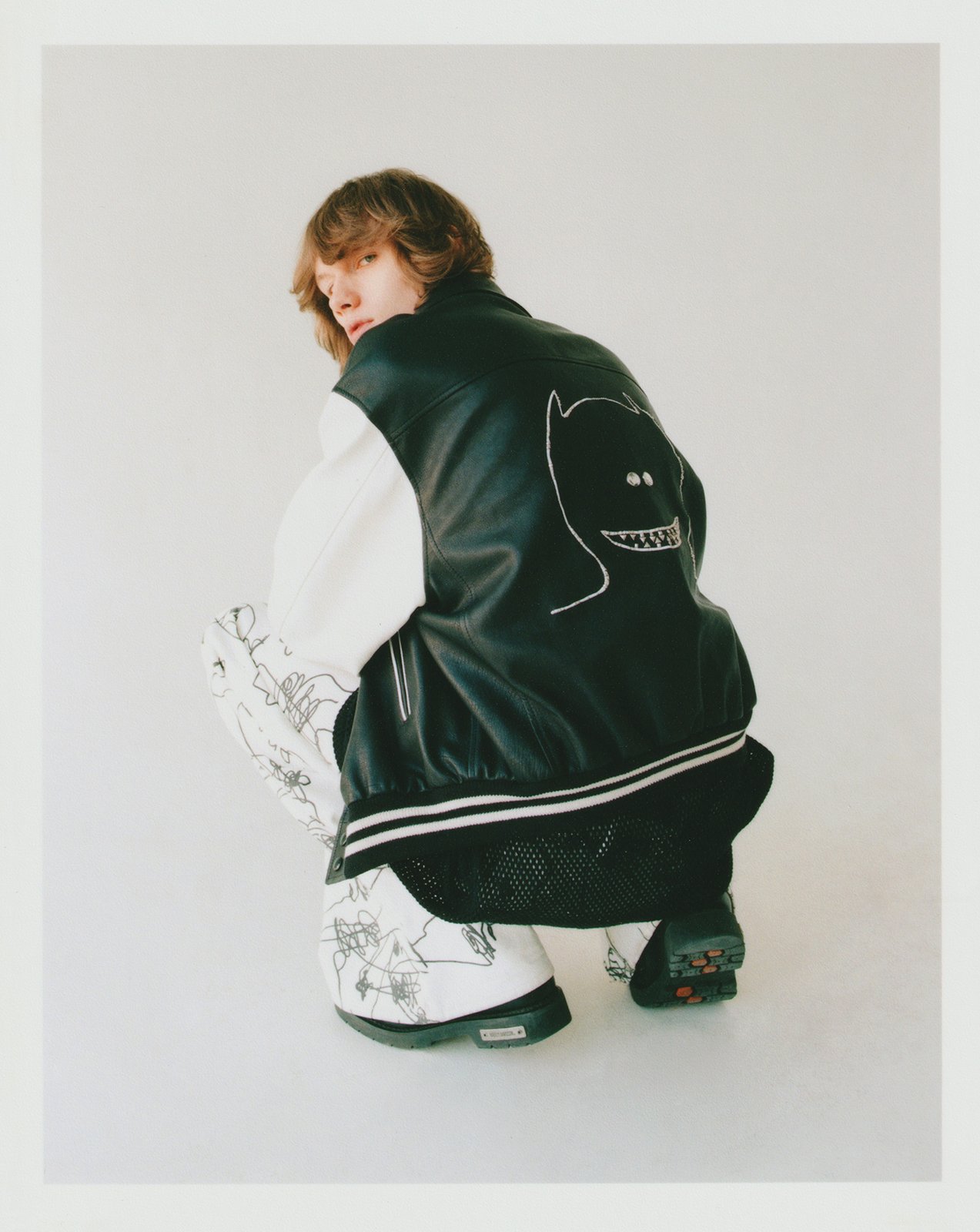 Thomas wears all by CELINE, earrings, boots, stylist