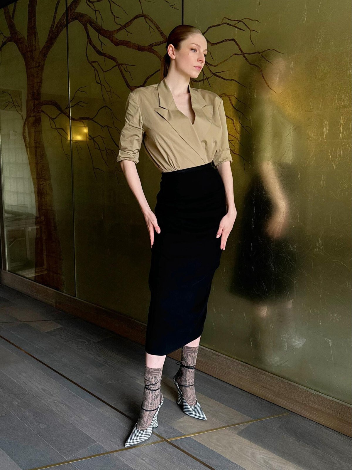 Hunter Schafer in a reflective pose, styled in Dries Van Noten's Spring-Summer 2024 collection, conveys the intricate depth of her "Cuckoo" character, Gretchen, at SXSW. (Photo Credit: Dara Allen)