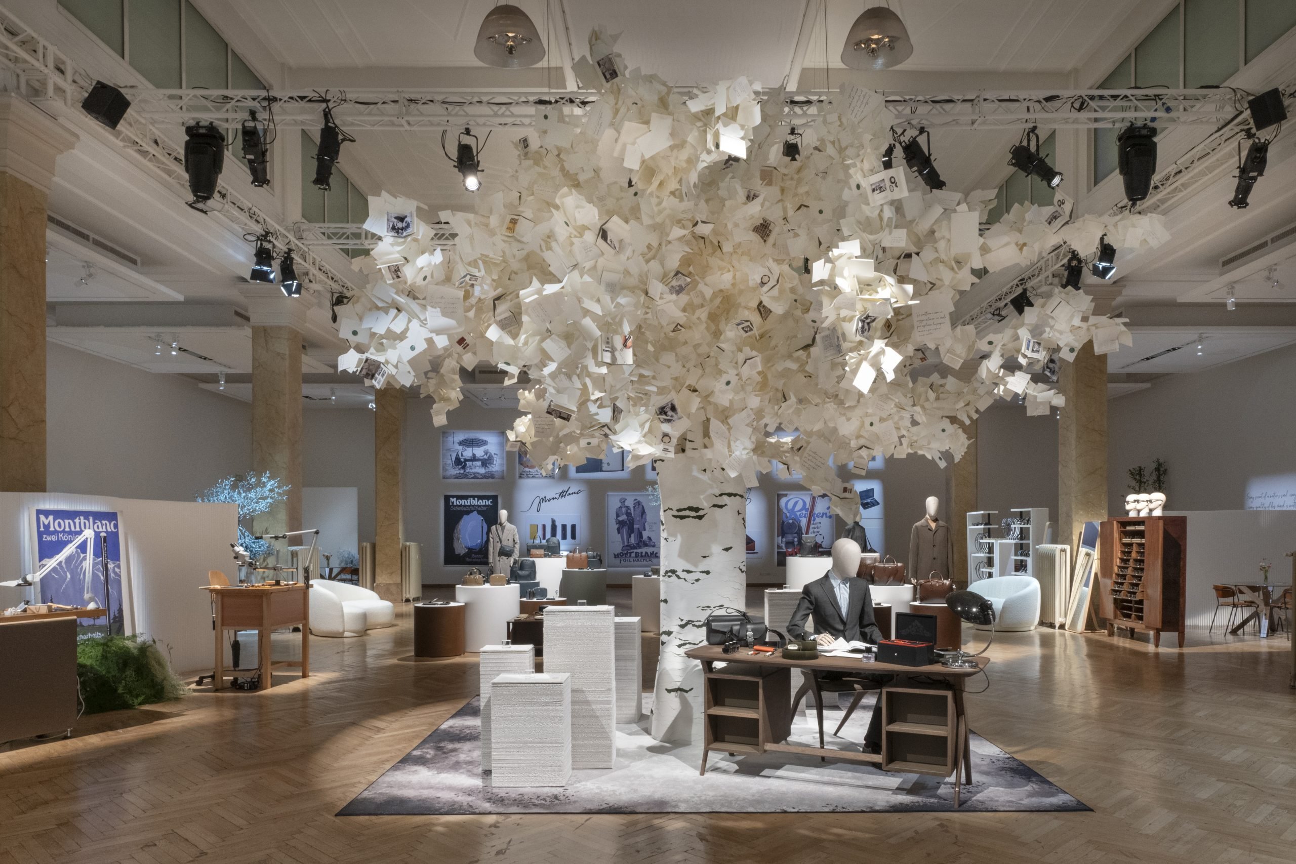 Montblanc's first venture into furniture design, the Montblanc Desk, appears beneath 'The Tree of Writing' installation, inviting guests to experience the art of writing at Salone dei Tessuti. (Photo: Courtesy of Montblanc)
