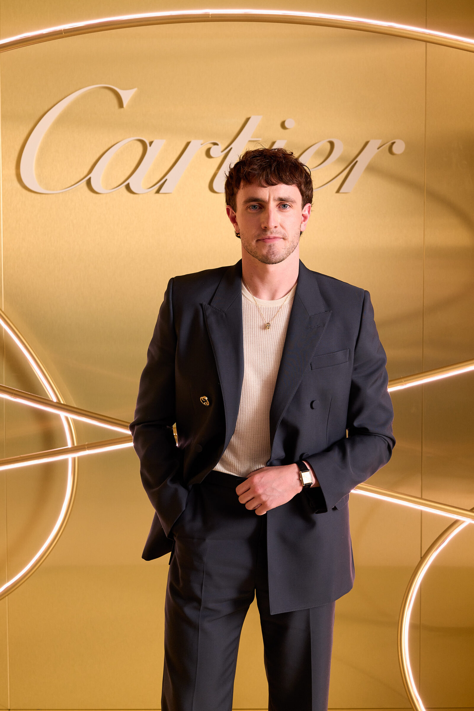Paul Mescal poses for a photo at the Paris Trinity Celebration, adorned in a Cartier tank timepiece and gold Cartier necklace. (Image courtesy of Pierre Mouton)