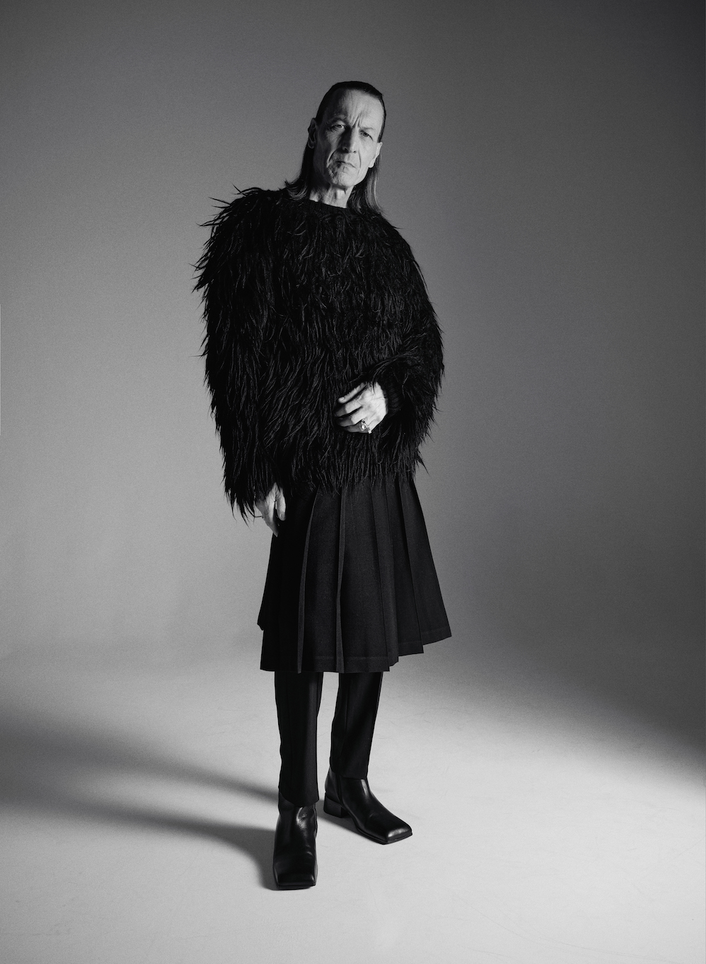 Sweater by JOHN LAWRENCE SULLIVAN, skirt by COMME DES GARÇONS, trousers by DRIES VAN NOTEN, boots by BALENCIAGA, rings by MIANSAI Sweater by JOHN LAWRENCE SULLIVAN, skirt by COMME DES GARÇONS, trousers by DRIES VAN NOTEN, boots by BALENCIAGA, rings by MIANSAI