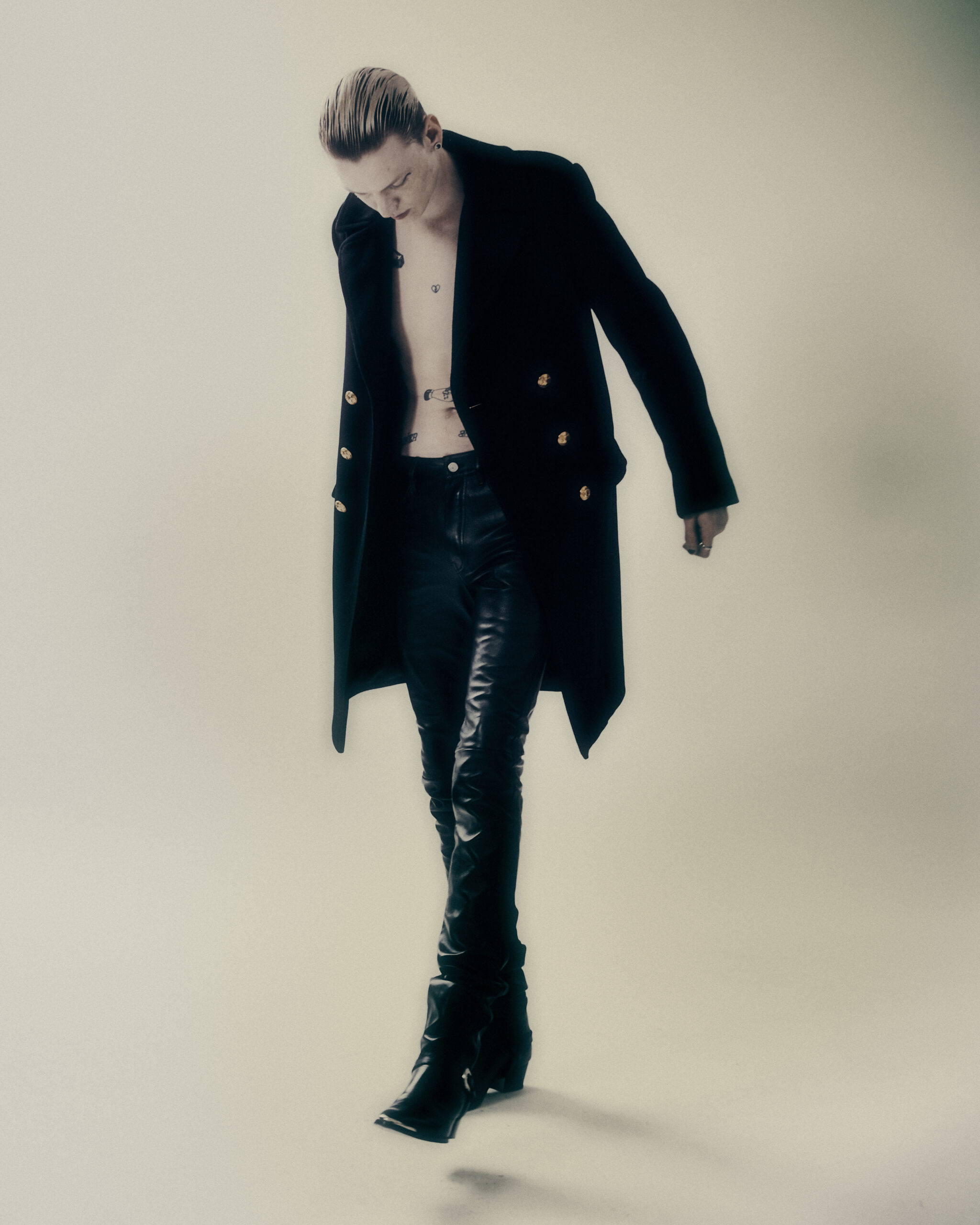 STAS wears coat, pants, and boots by CELINE