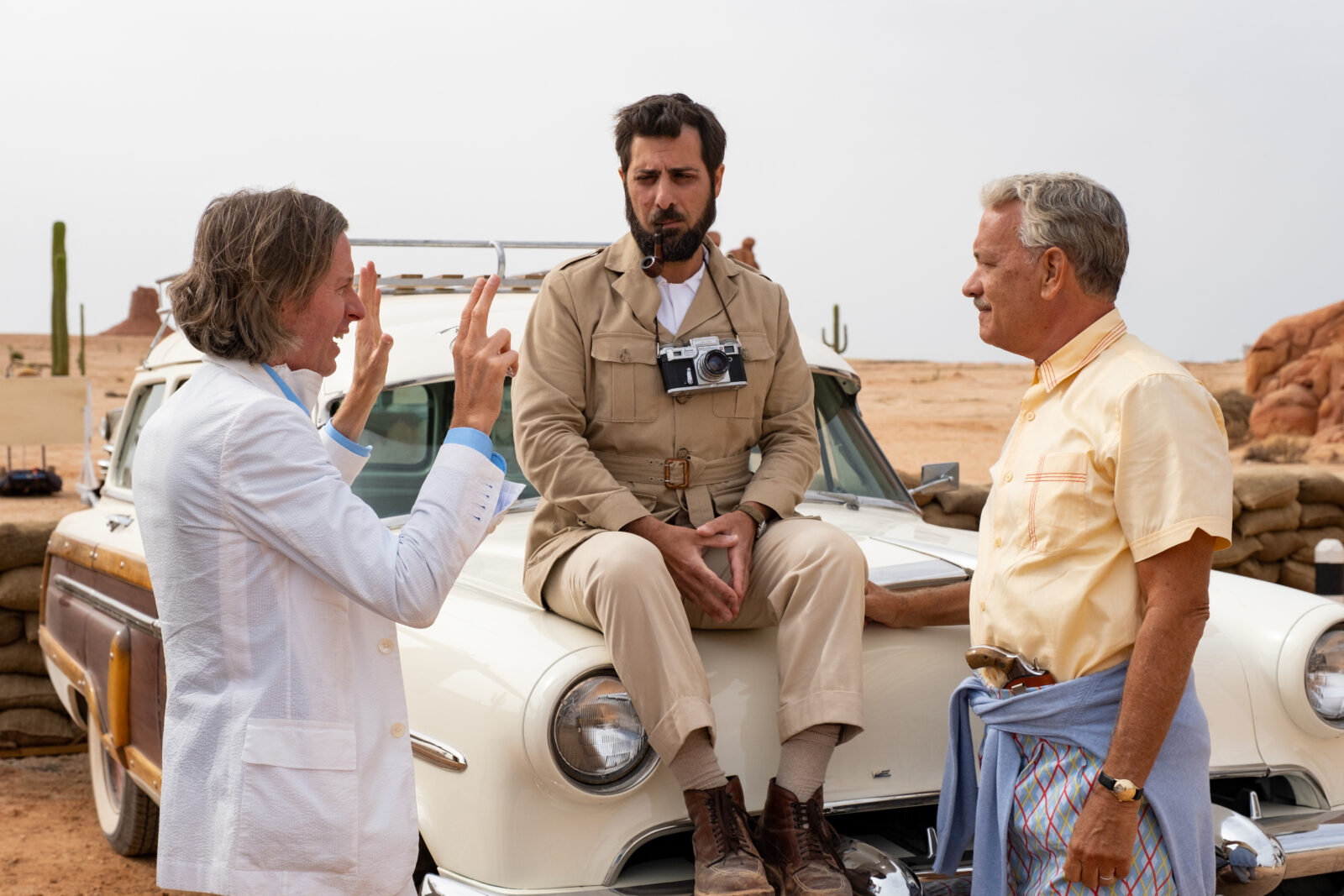 (L to R) Writer/director Wes Anderson, actor Jason Schwartzman and actor Tom Hanks on the set of ASTEROID CITY, a Focus Features release. Credit: Courtesy of Roger Do Minh/Pop. 87 Productions/Focus Features (L to R) Writer/director Wes Anderson, actor Jason Schwartzman and actor Tom Hanks on the set of ASTEROID CITY, a Focus Features release. Credit: Courtesy of Roger Do Minh/Pop. 87 Productions/Focus Features