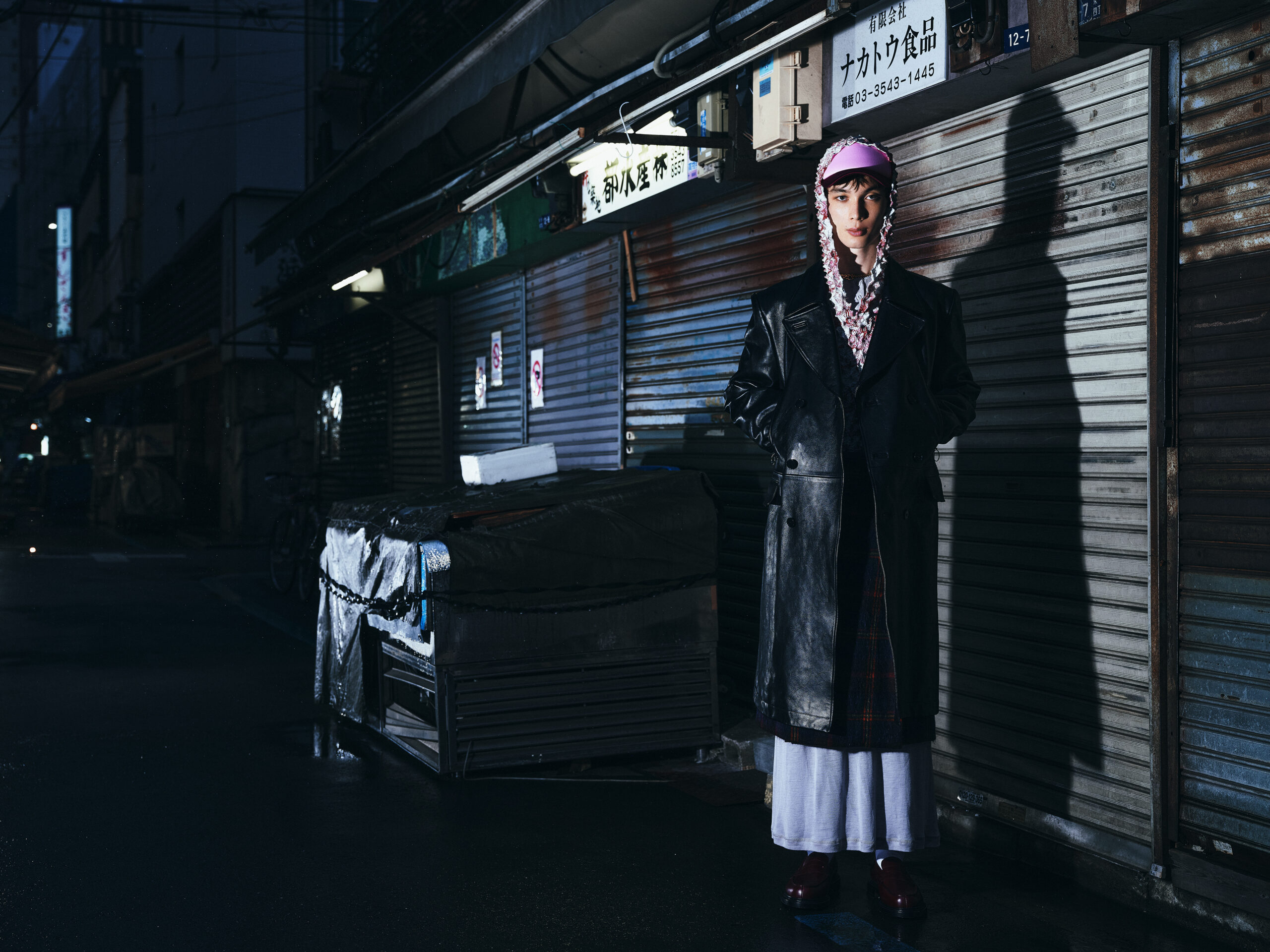 Coat by JOHN LAWRENCE SULLIVAN, hoodie by MASU, dress by SAMUEL GUÌ YANG, kilt by NICHOLAS DALEY, shoes by J.M. WESTON, socks, stylist’s own, cap by STOCKHOLM SURFBOARD CLUB, glasses by GENTLE MONSTER, necklace by ALL BLUES.