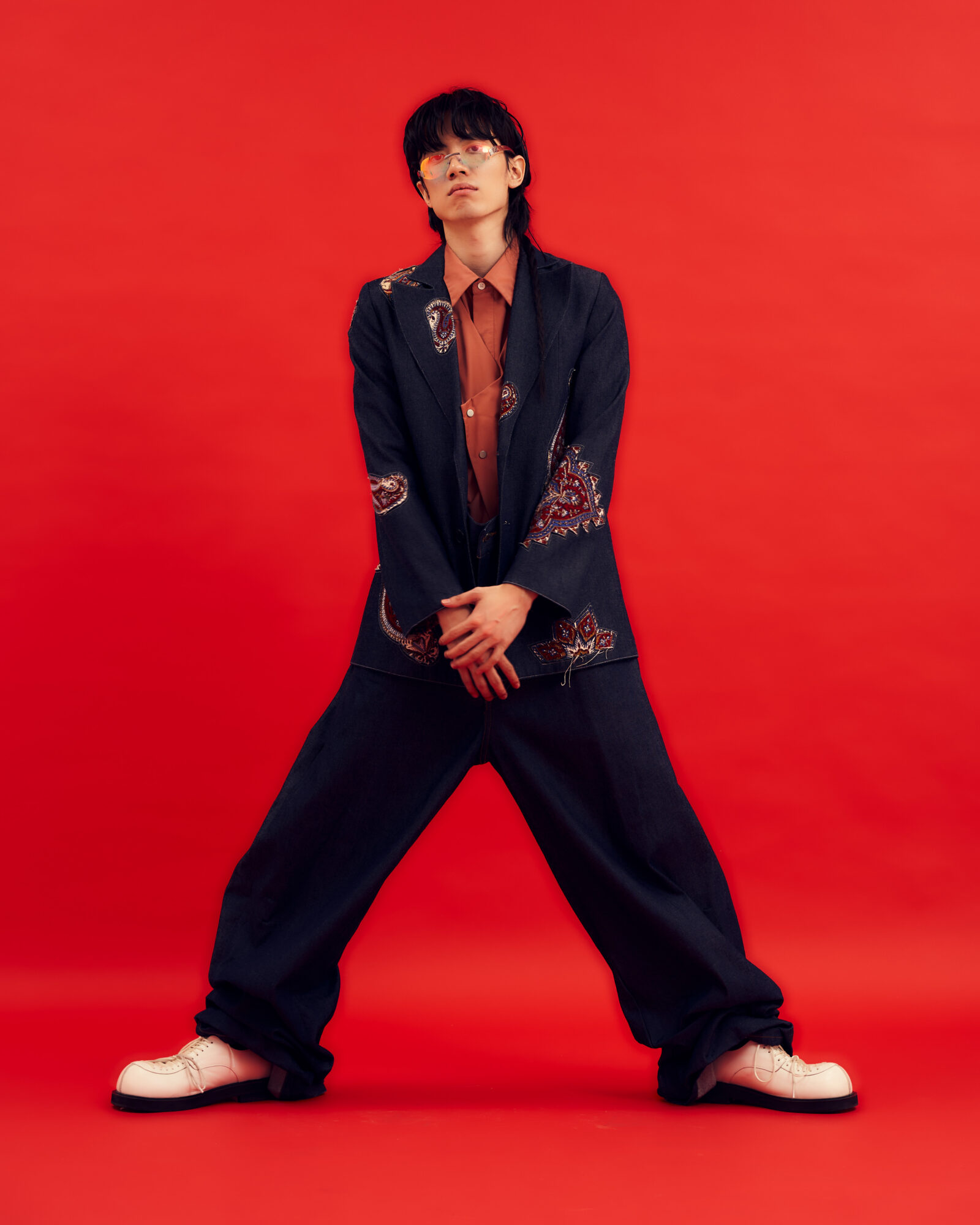 Jacket by PARIAFARZANEH, shirt by UMAMIISM, pants by FACETASM, shoes by NIWWTW, eyewear by CHANEL.