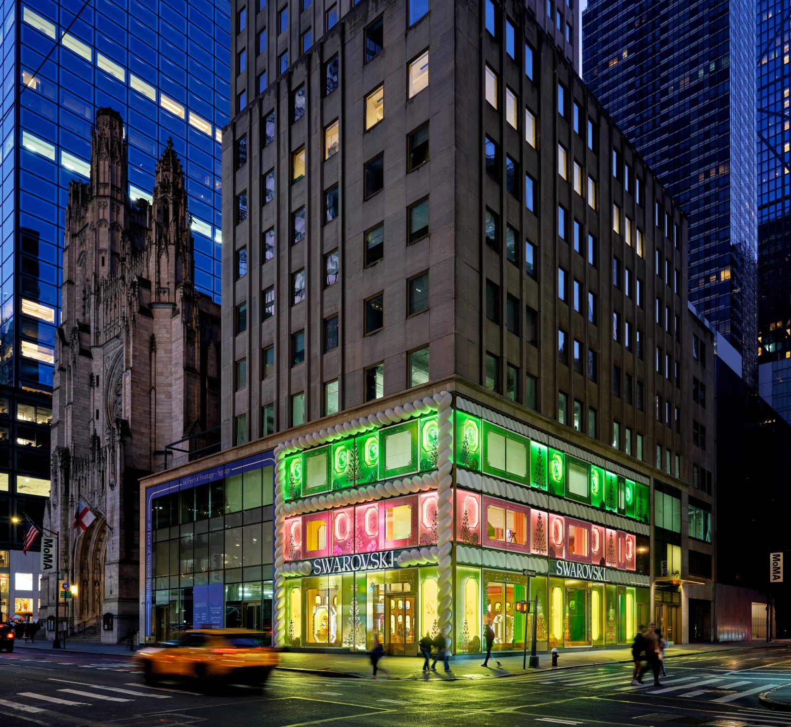 Swarovski’s Fifth Avenue flagship glows in the Manhattan twilight, its festive green and pink theme contrasting with the surrounding neighborhood. (Photo: Courtesy of Swarovski)
