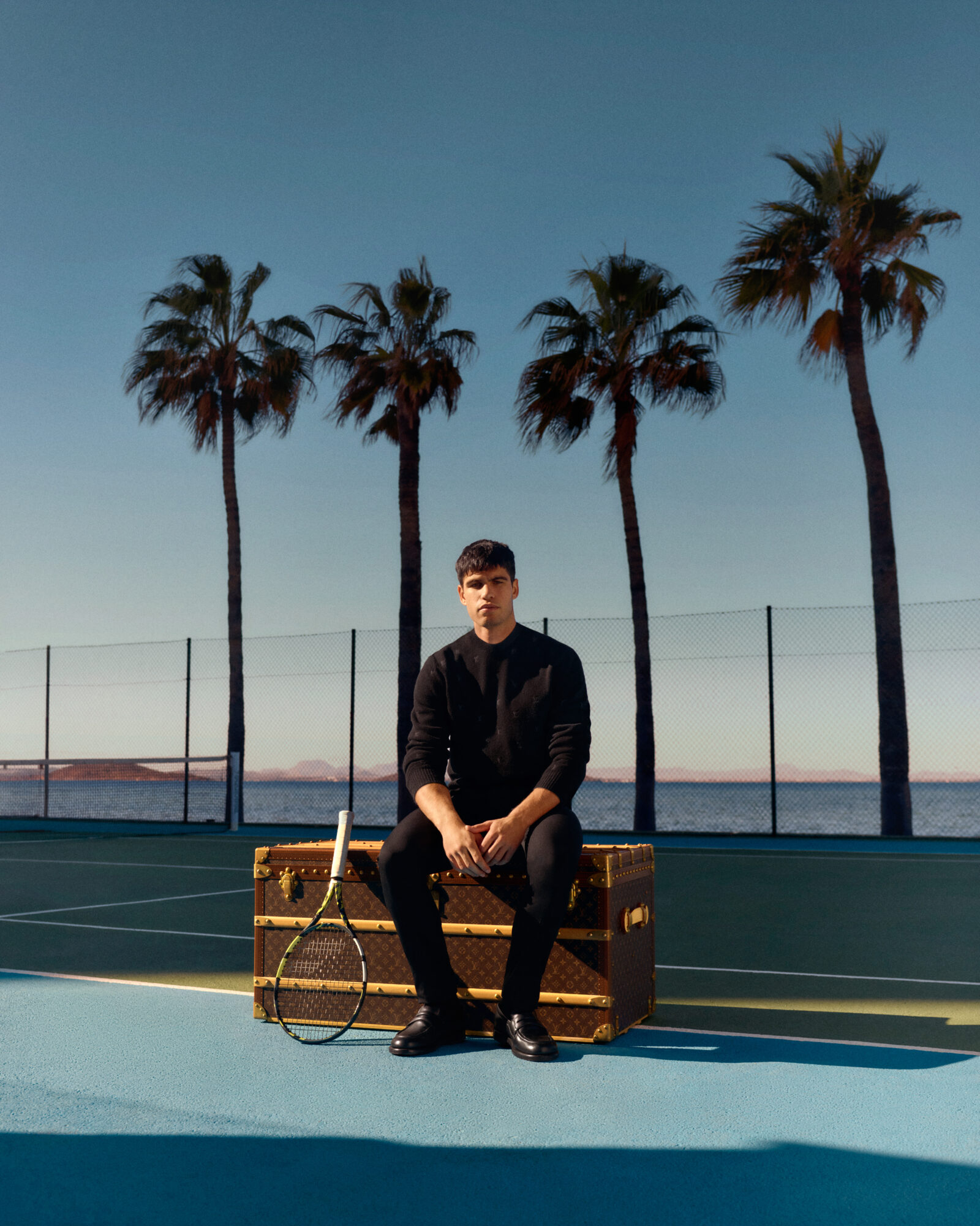 Contemplative Champion: Alcaraz in a moment of reflection, adorned in Louis Vuitton's timeless elegance.
