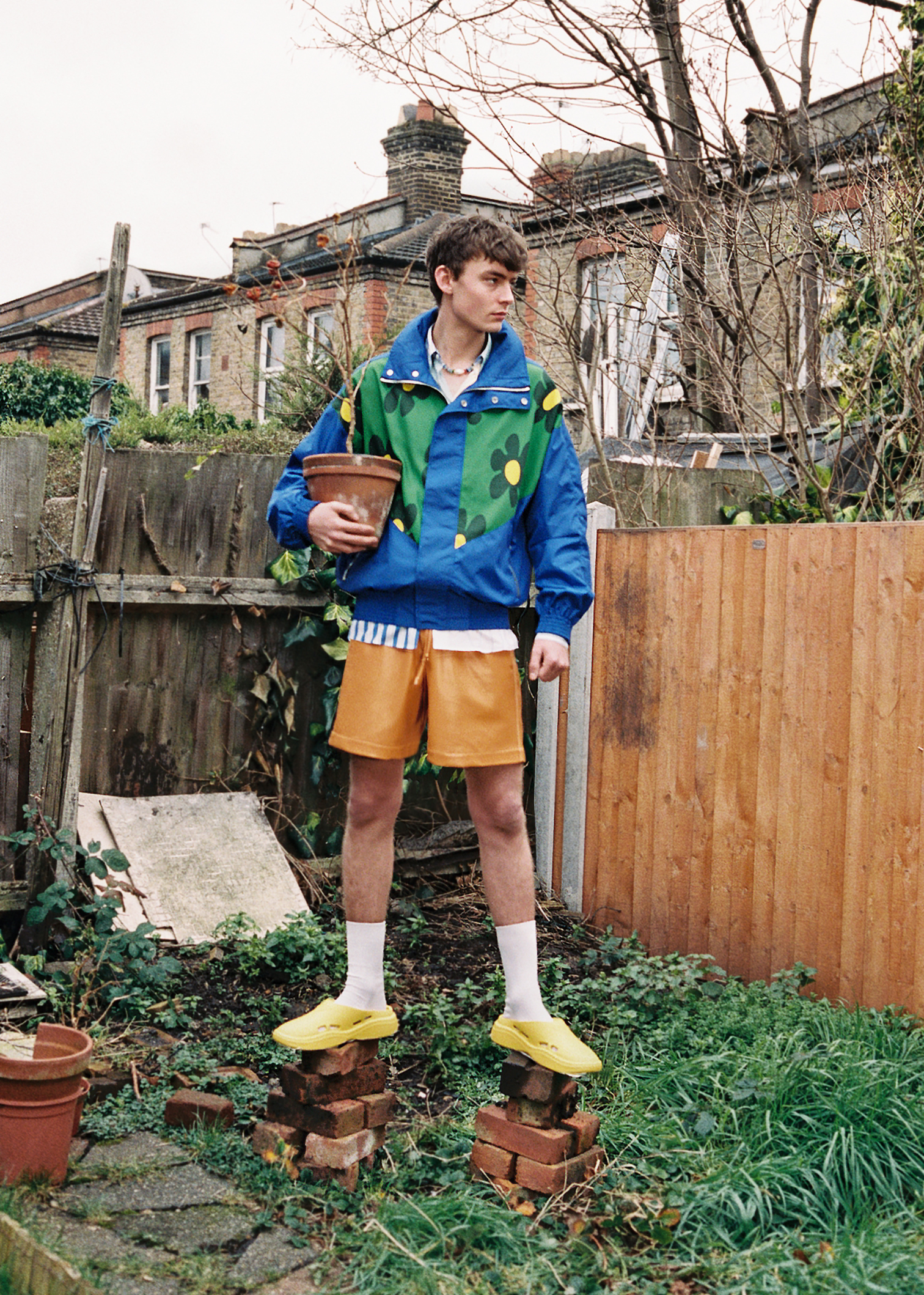 Jacket and shirt by JW ANDERSON, shorts by NANUSHKA, shoes by PRADA, necklace by ELIOU
