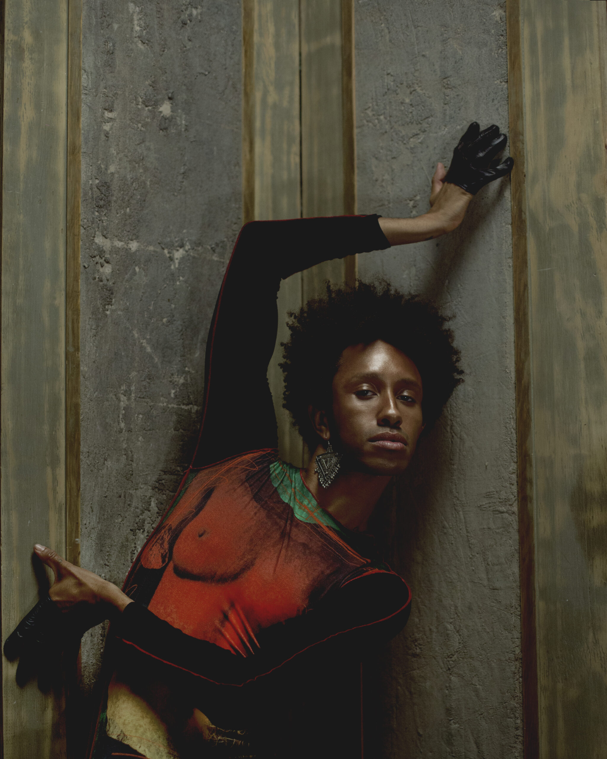 Top by JEAN PAUL GAULTIER, earring, stylist's own, gloves by PAULA ROWAN