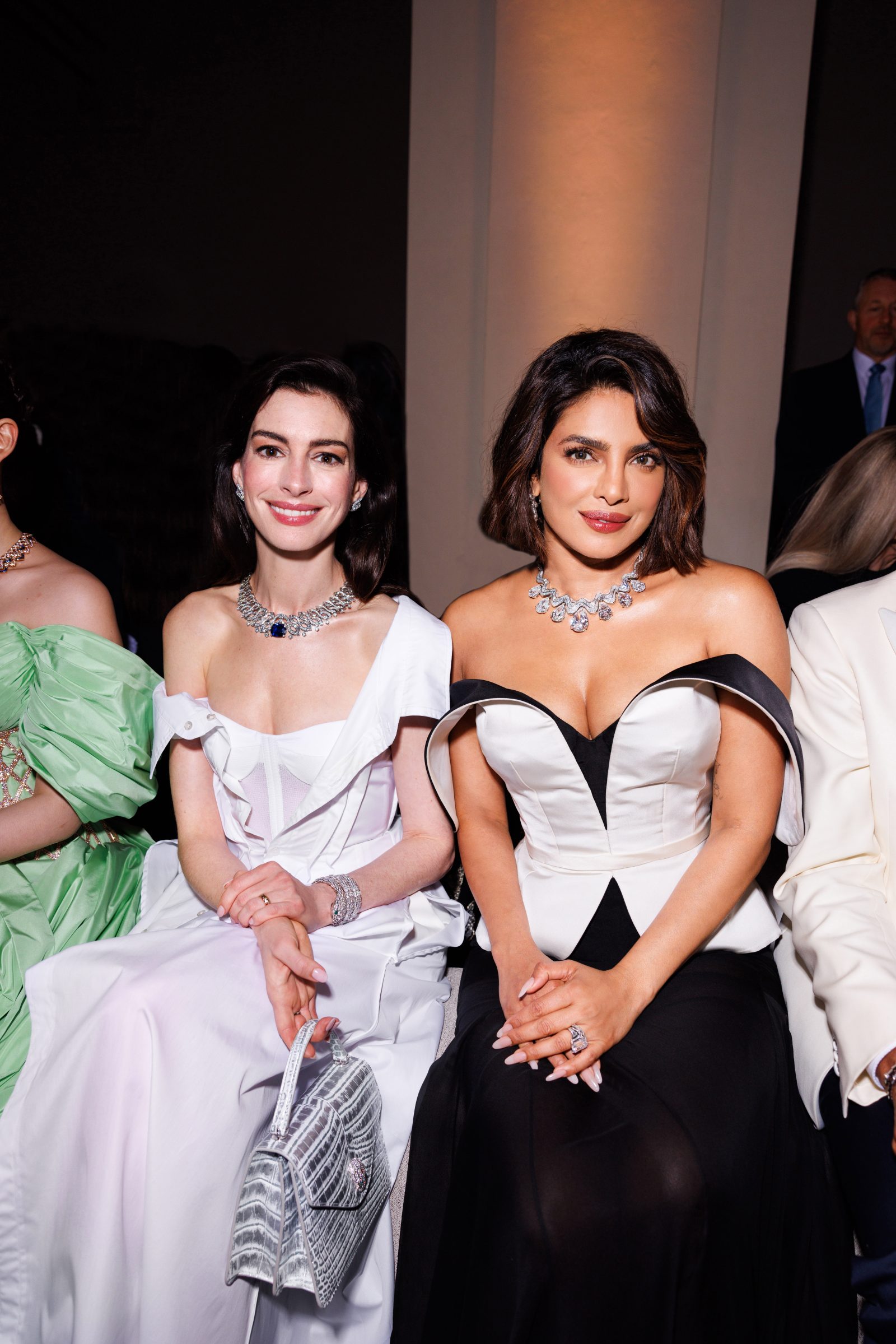 Anne Hathaway and Priyanka Chopra Jonas, both stunning in Bvlgari jewels, share a moment of camaraderie at the Aeterna High Jewelry event in Rome, celebrating 140 years of the brand's timeless elegance and exquisite craftsmanship.