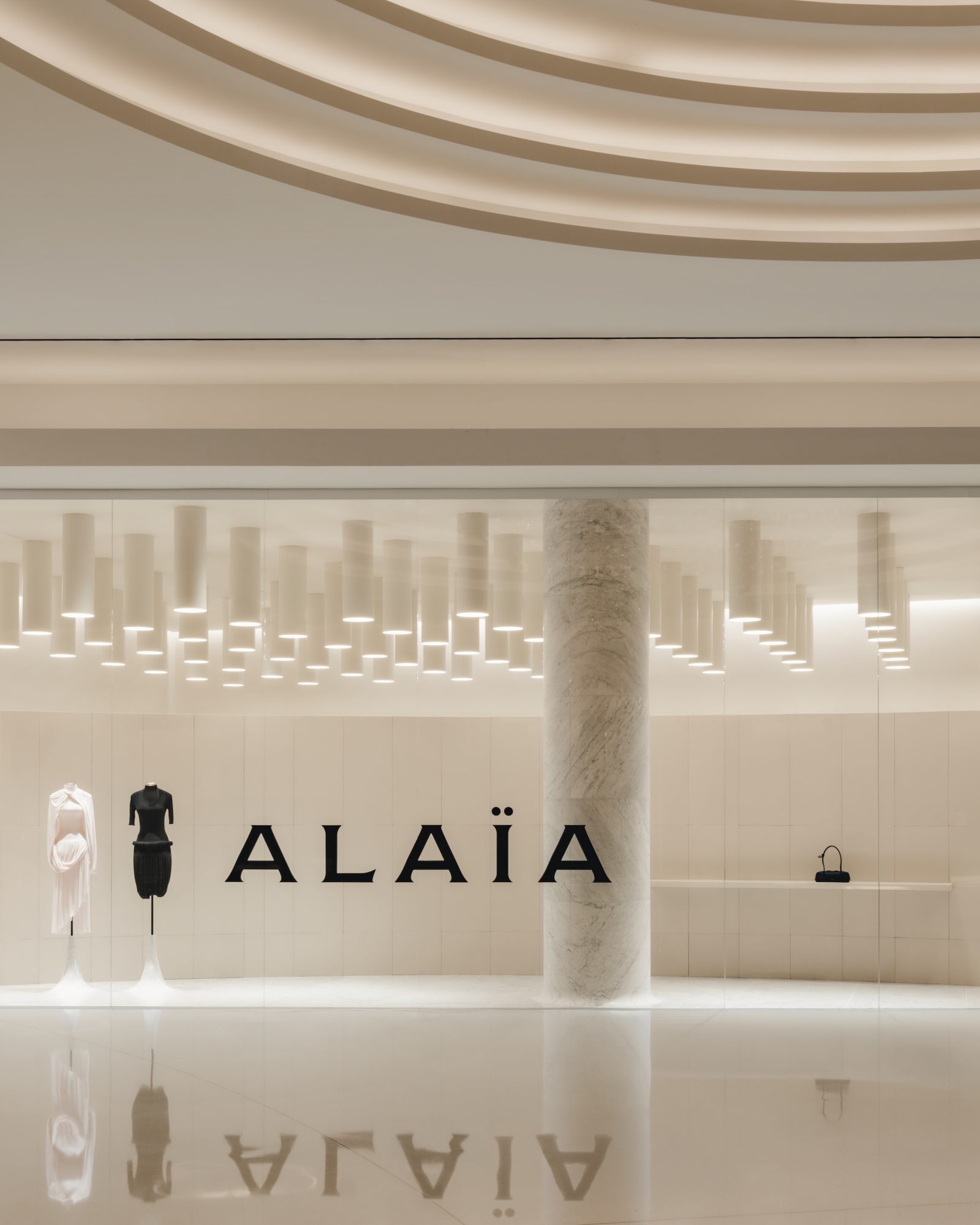 The Fontainebleau Las Vegas boutique features an innovative ceiling installation of descending light tubes, complemented by reflective surfaces and contemporary display elements. (Photos courtesy of ALAÏA) ALAIA FONTAINEBLEAU