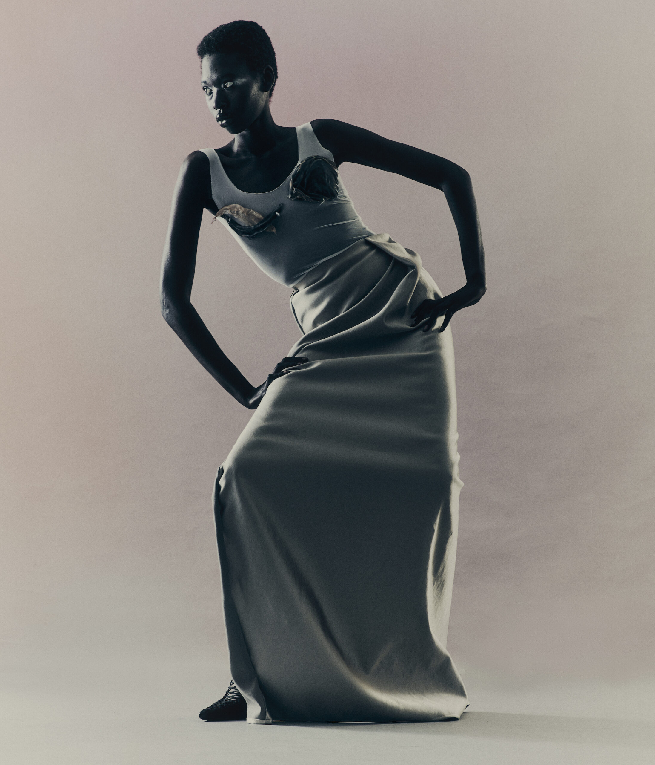 Awet wears top and skirt by KIM MESCHES, shoes by GIVENCHY