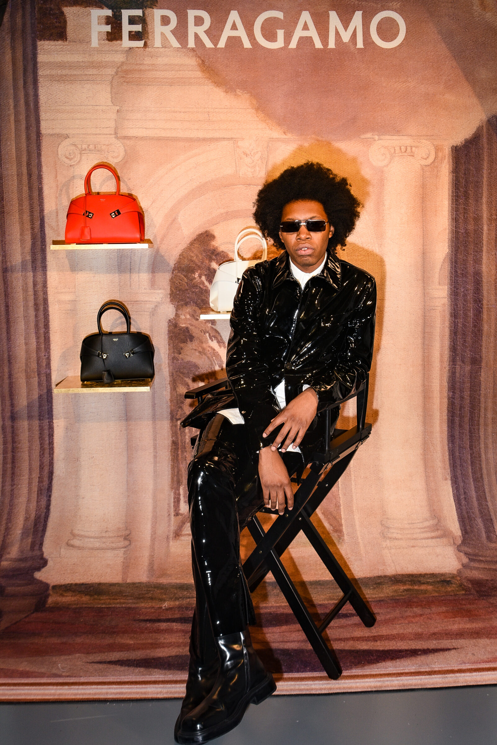 Jeremy O'Harris exuding style and confidence at the Ferragamo Fall-Winter 2023 event, surrounded by the brand's latest handbag creations. Photo courtesy of Ferragamo. Jeremy O