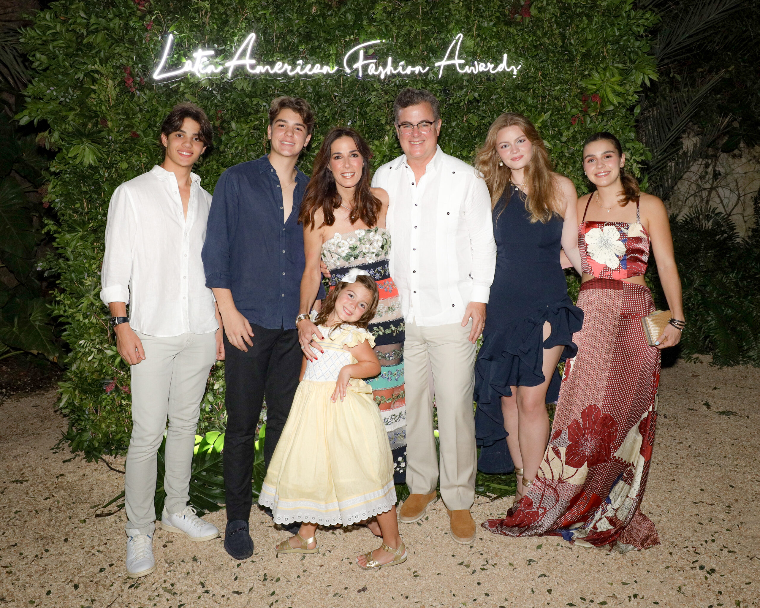 A moment of radiance: Silvia Argüello, surrounded by her family, captures the joy and familial bonds at the Latin American Fashion Awards, set against an oasis of greenery. (Photo credit: Shane Drummond/BFA.com courtesy of Purple PR) "A moment of radiance: Silvia Argüello, surrounded by her family, captures the joy and familial bonds at the Latin American Fashion Awards, set against an oasis of greenery."