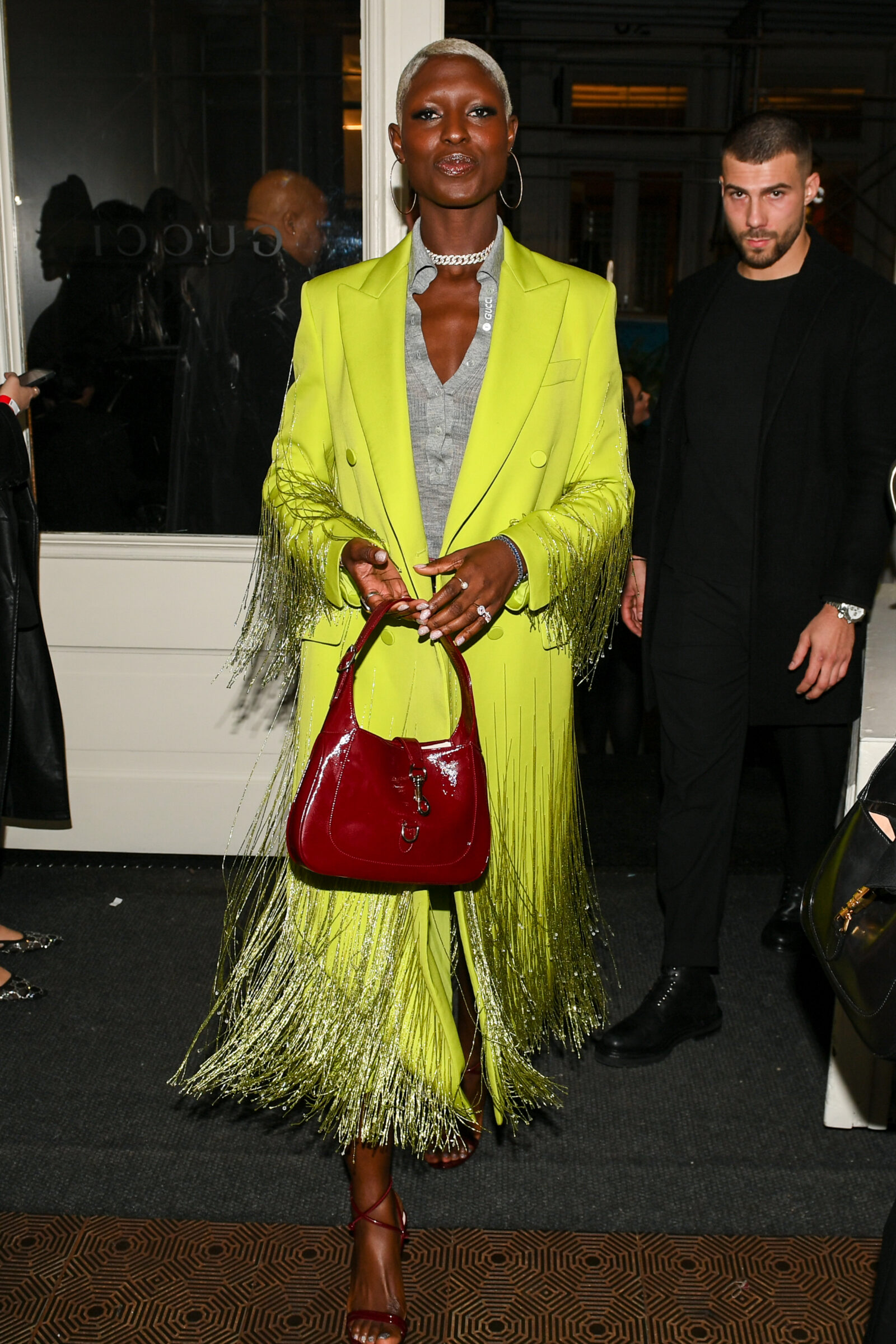 Jodie Turner-Smith embodies the bold and joyous spirit of the Gucci SS24 Ancora collection, wearing a dazzling green coat and Jackie Notte bag.