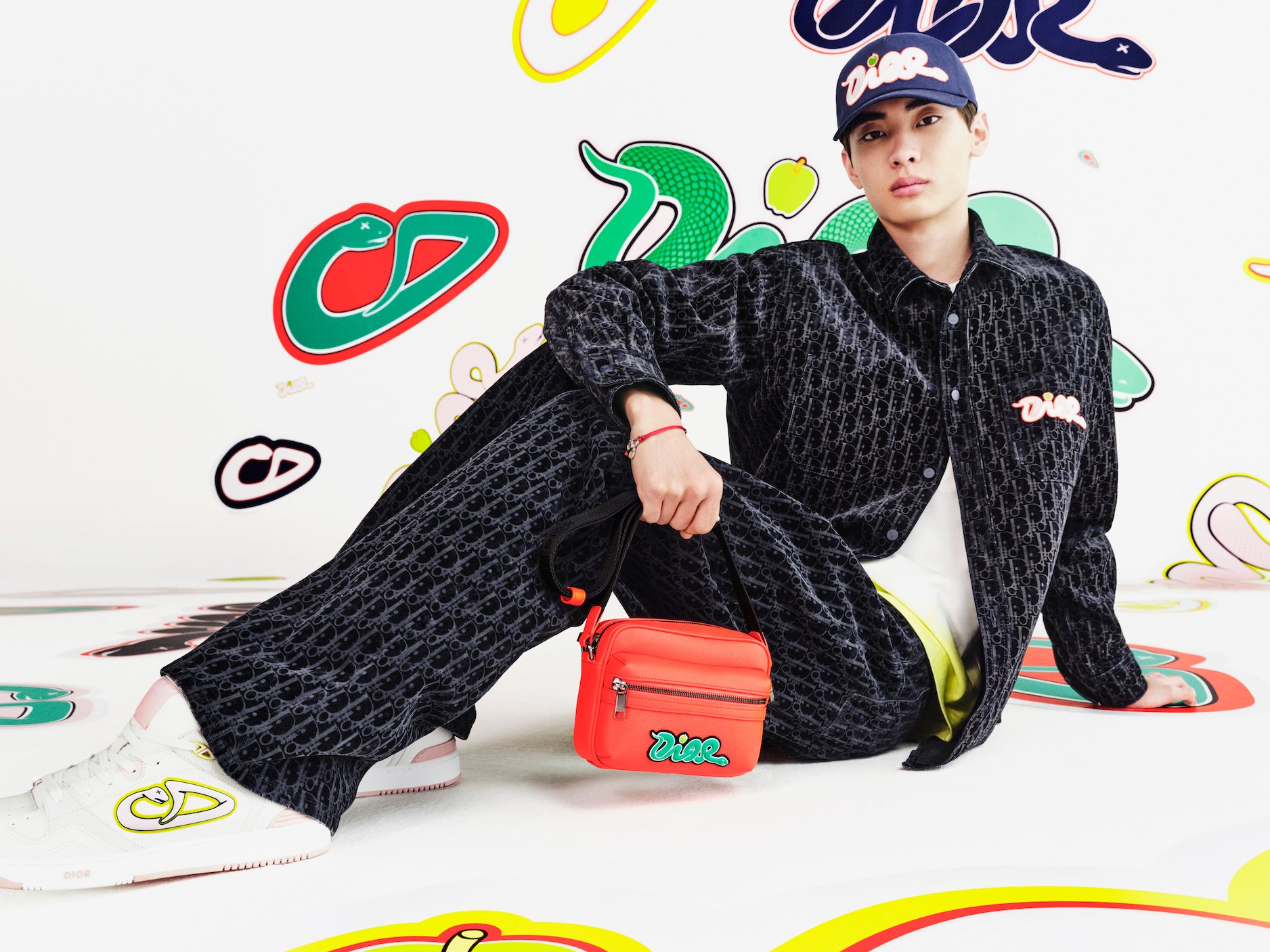 Heritage meets contemporary: the Oblique monogram denim ensemble gains street credibility with the collection's signature messenger bag in striking red. (Image: Courtesy of Dior)