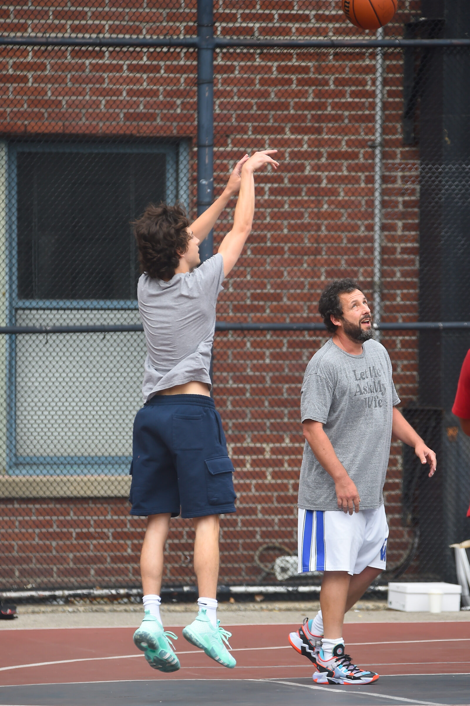 Timothee Chalamet and Adam Sandler are seen playing basketball in Soho on July 20, 2023 in New York City. (Photo by Raymond Hall/GC Images/Getty Images).