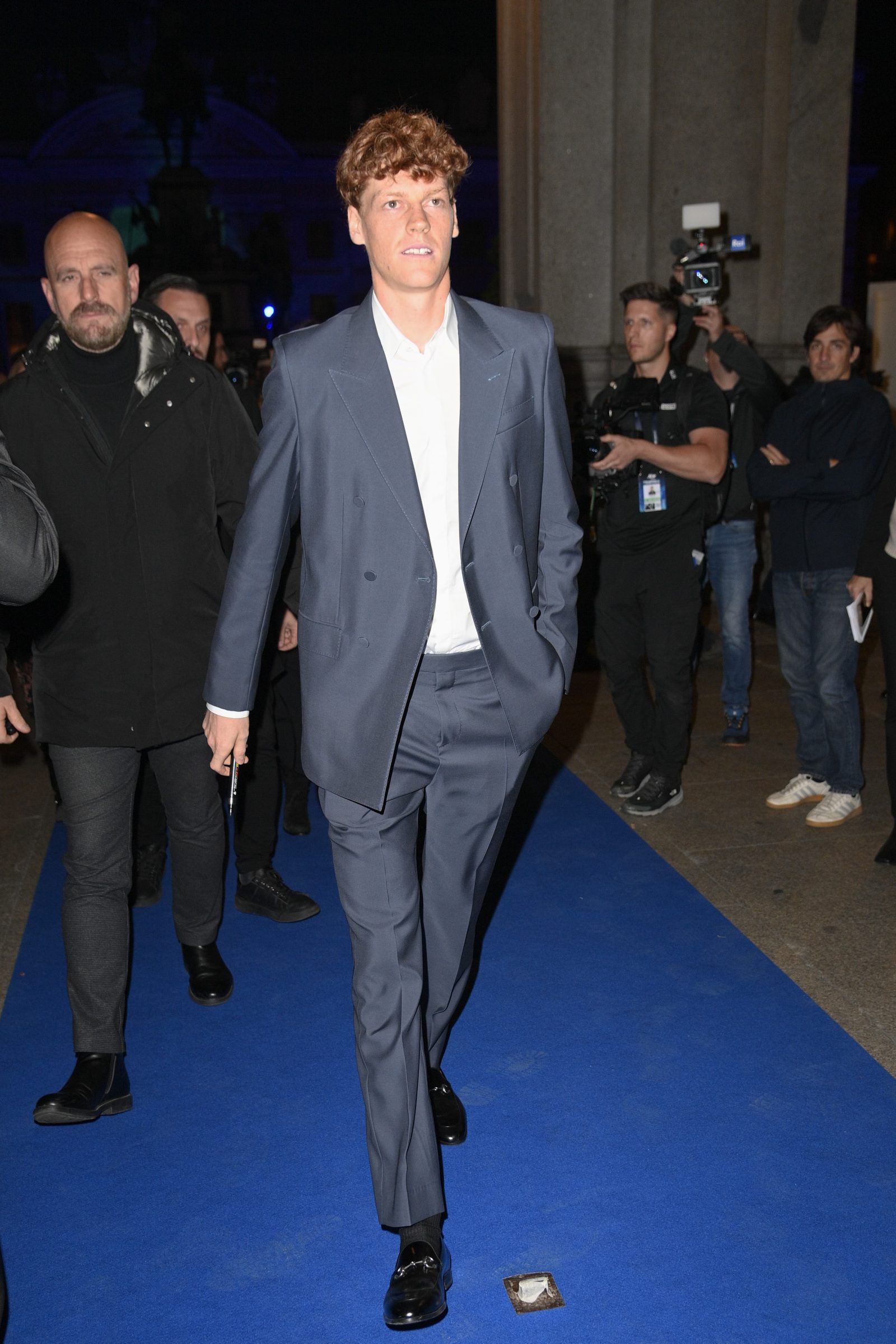 Jannik Sinner arrives at the ATP Finals blue carpet event wearing a custom Gucci wool double-breasted blue suit paired with a white shirt and Horsebit-detailed black leather loafers at Piazza Carlo Alberto in Turin, Italy (Image: Courtesy of Gucci/Getty)