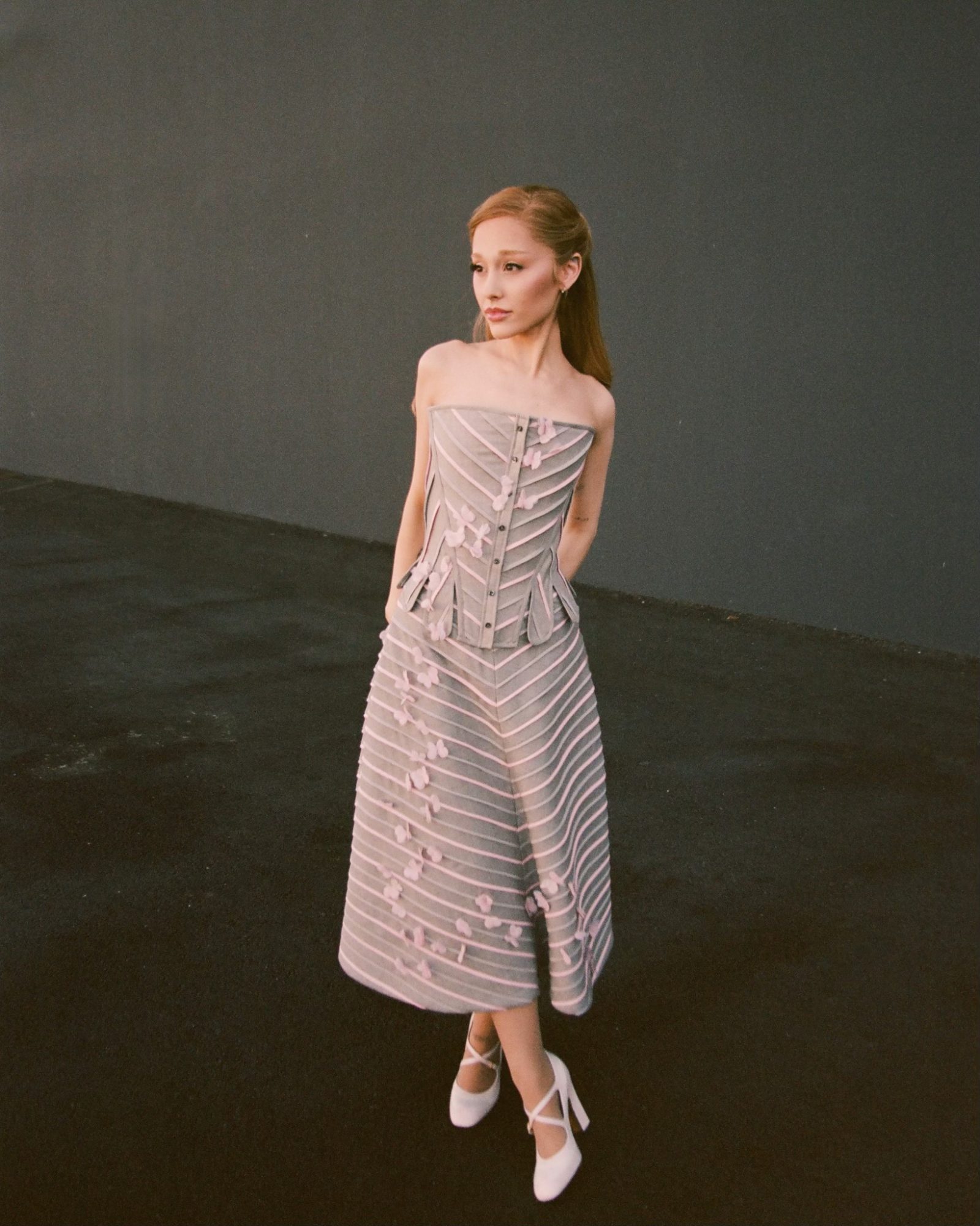 Ariana Grande wears a custom Thom Browne light grey wool corset and tiered skirt with pink butterfly appliqués at the “Wicked” press event in Los Angeles. (Image: Courtesy of Thom Browne)