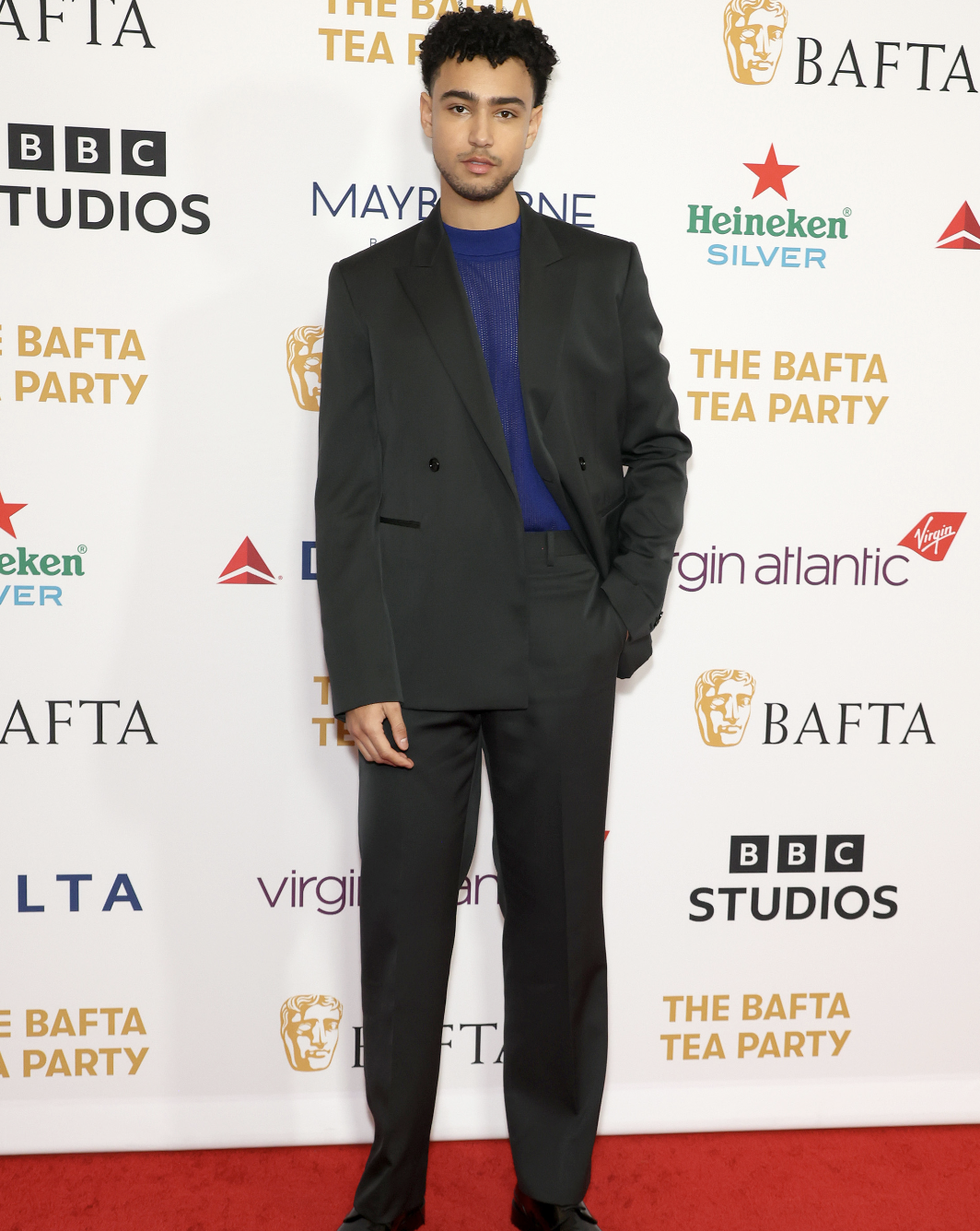 Archie Madekwe exudes modern elegance at the BAFTA Tea Party—a testament to his seamless blend of classic and contemporary style. Image courtesy of Burberry.