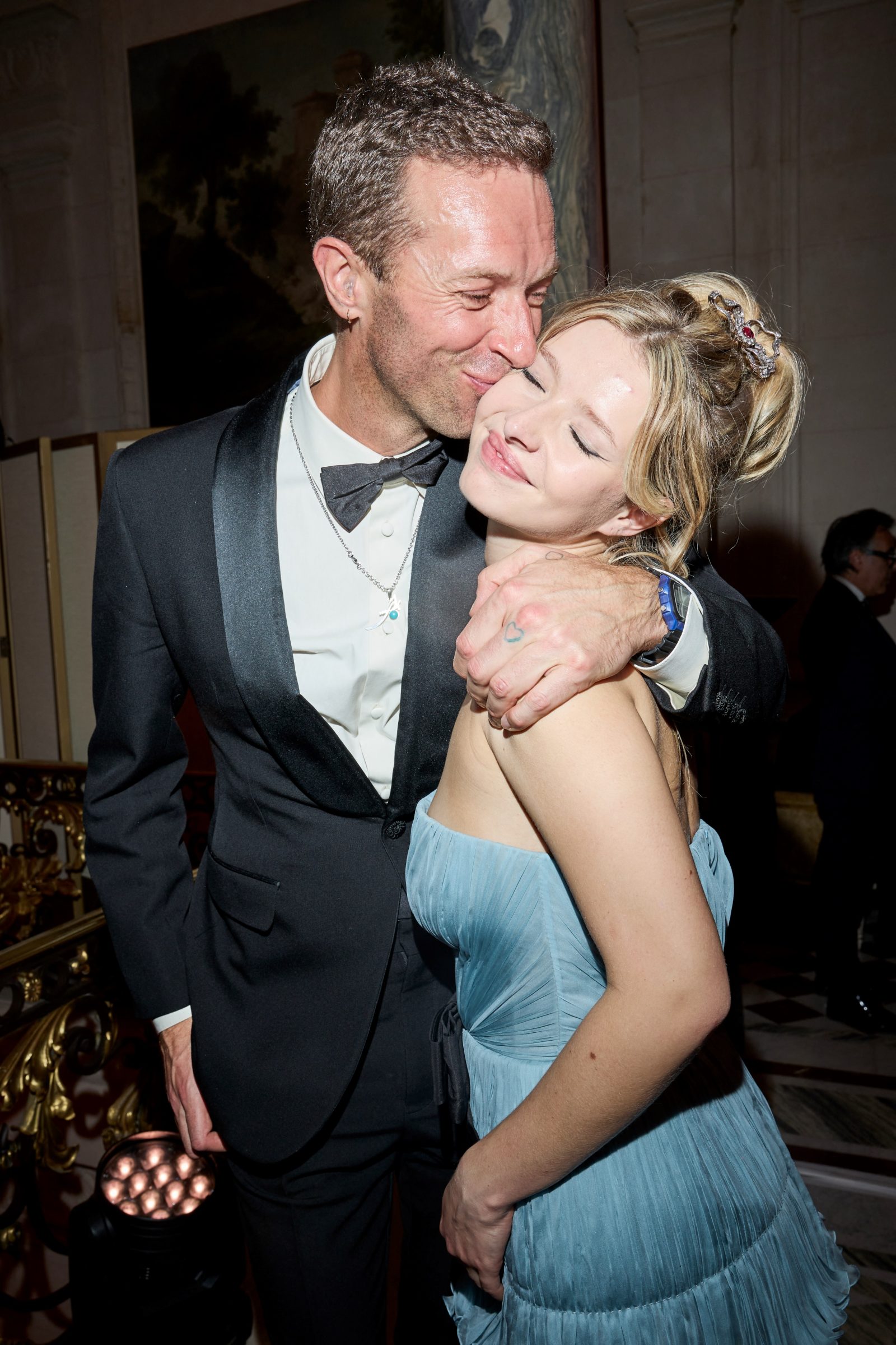Father and daughter: Chris Martin, wearing a custom Valentino tuxedo by Alessandro Michele, shares a moment with Apple Martin, who stuns in an ethereal blue gown at Le Bal des Débutantes in Paris. (Photo: Le Bal/Borde/Moreau/Bestimage)
