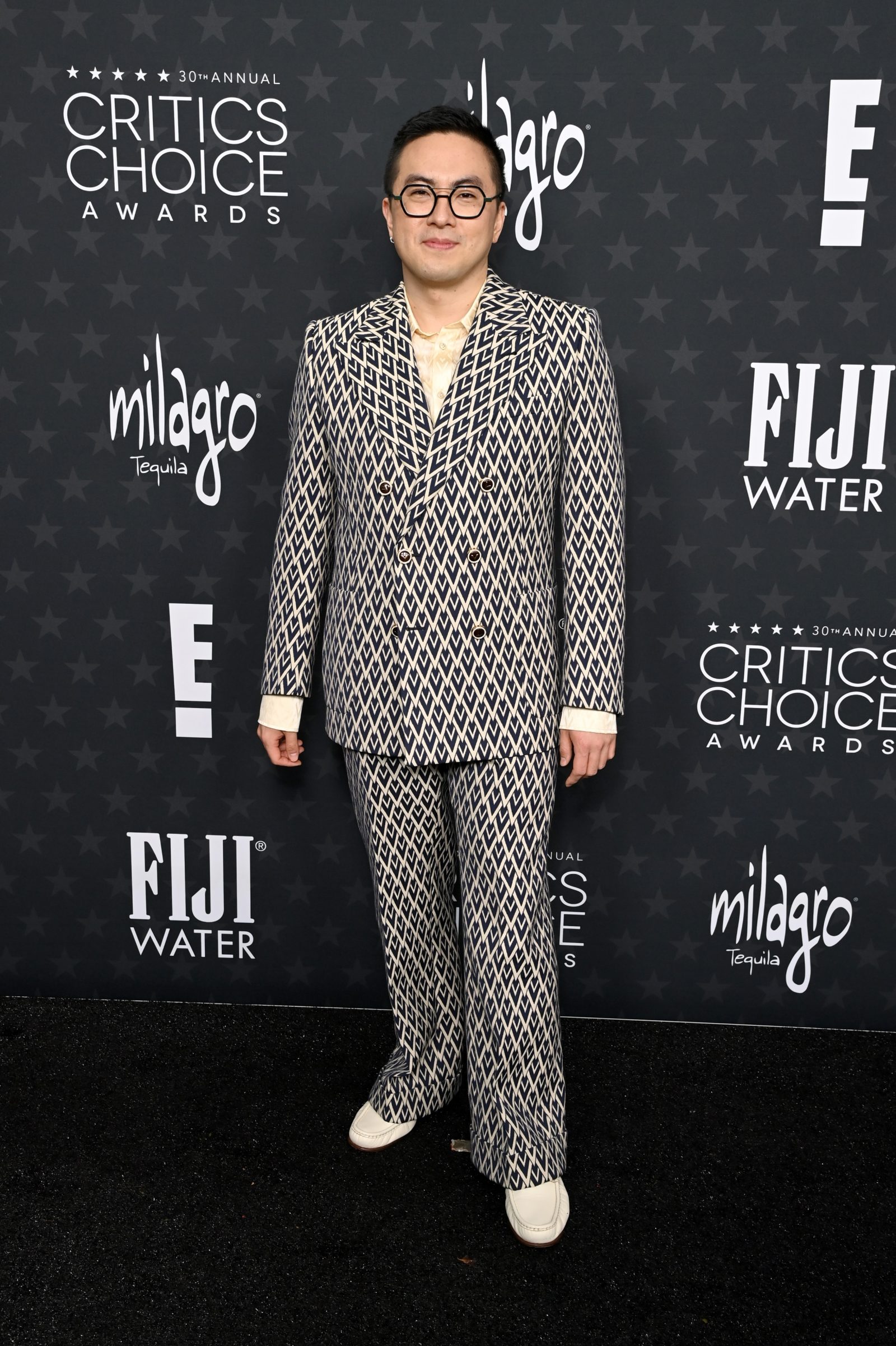 Bowen Yang attends the 30th Annual Critics Choice Awards at Barker Hangar on February 7th in Santa Monica, California. (Photo Courtesy of Valentino)