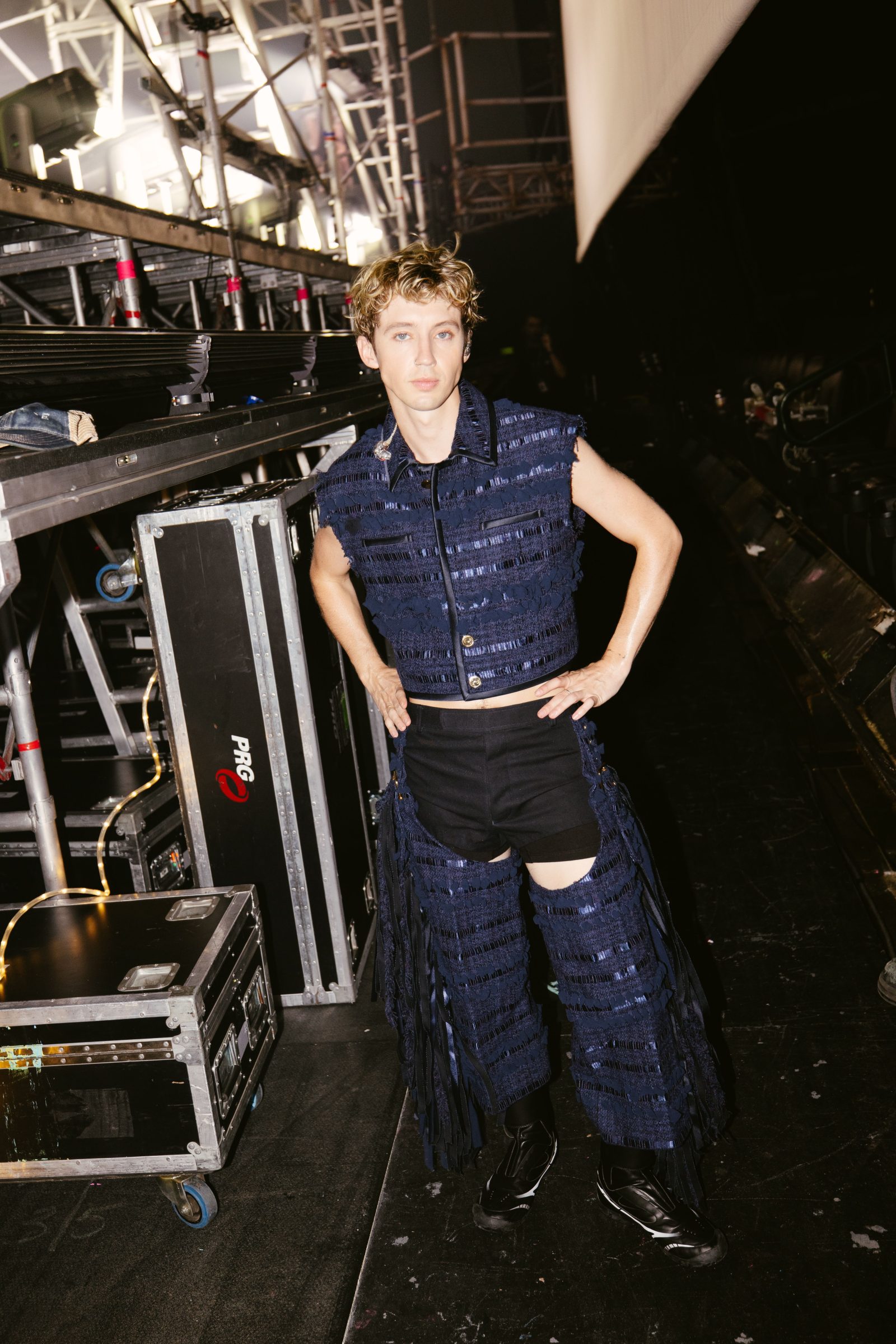 Troye Sivan is photographed backstage during his Dallas “Sweat Tour” performance wearing a look from Thom Browne.