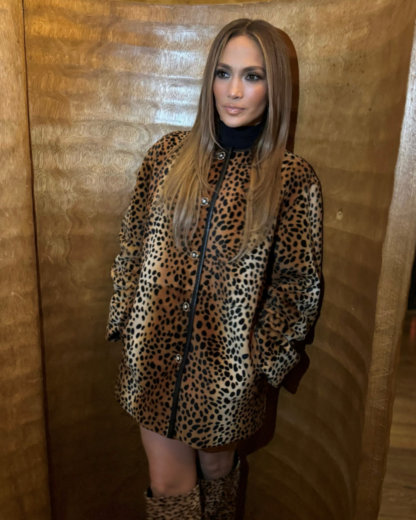 Global icon Jennifer Lopez channels Versace's bold spirit in London, wearing a leopard-print leather coat and knee-high Opera Bow boots from the Resort 2025 collection.