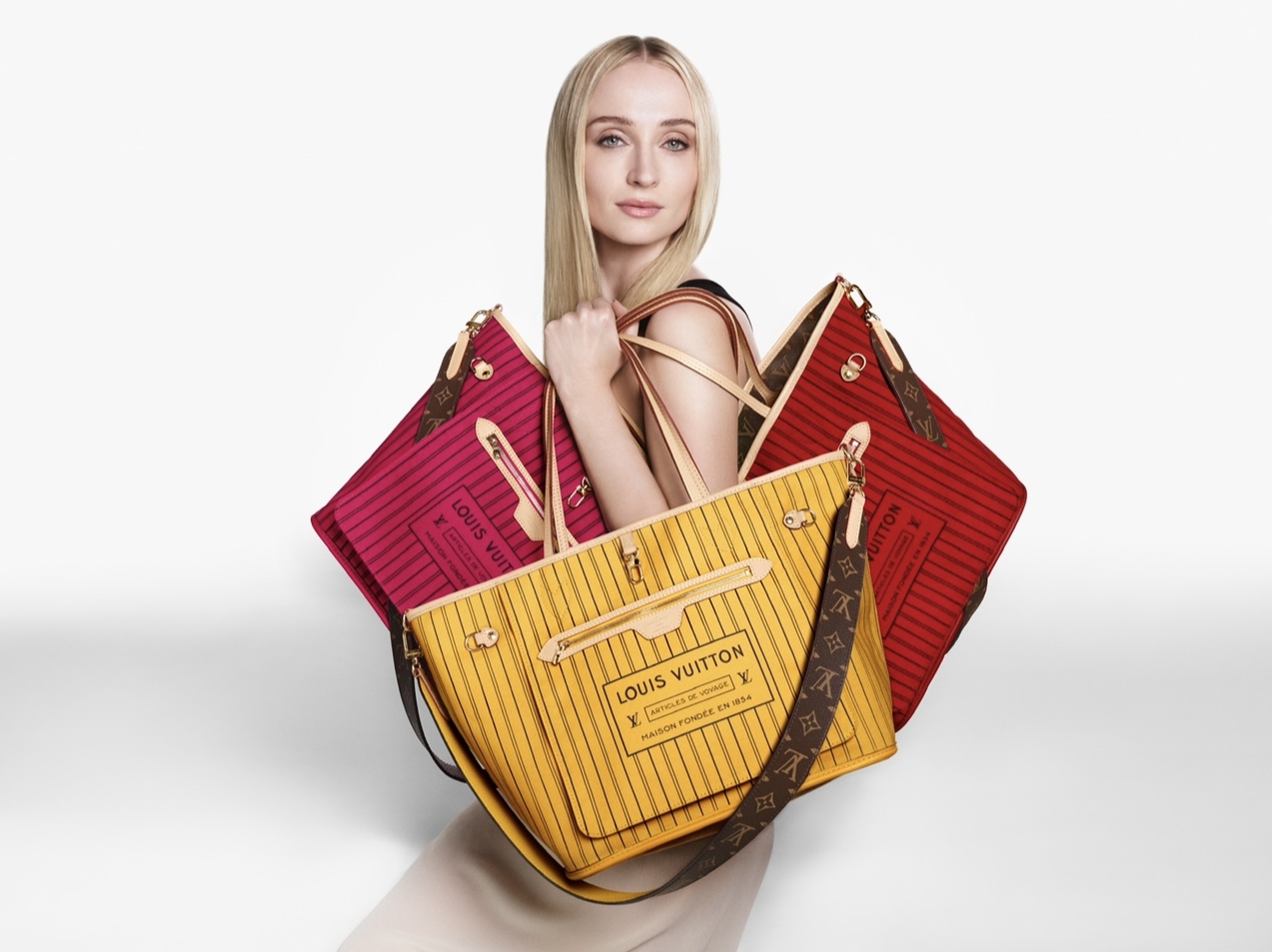Sophie Turner stars as muse for the new Louis Vuitton Inside Out Collection, with the bag interior facing.