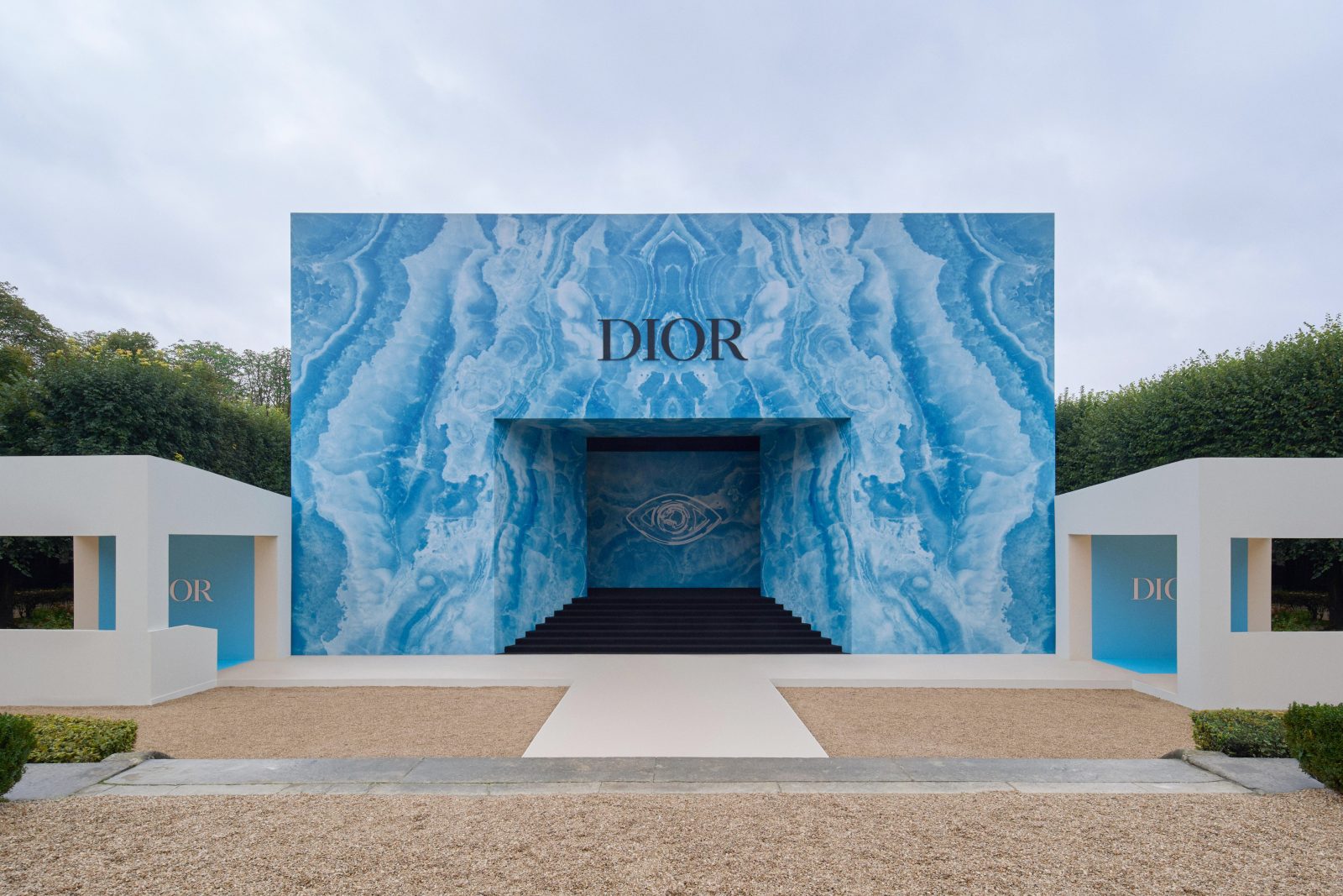 DIOR presented the Women's Spring-Summer 2025 collection, transforming the exterior of Musée Rodin into a phantasmic display of color, while the interior runway showcased a predominantly black and white collection.