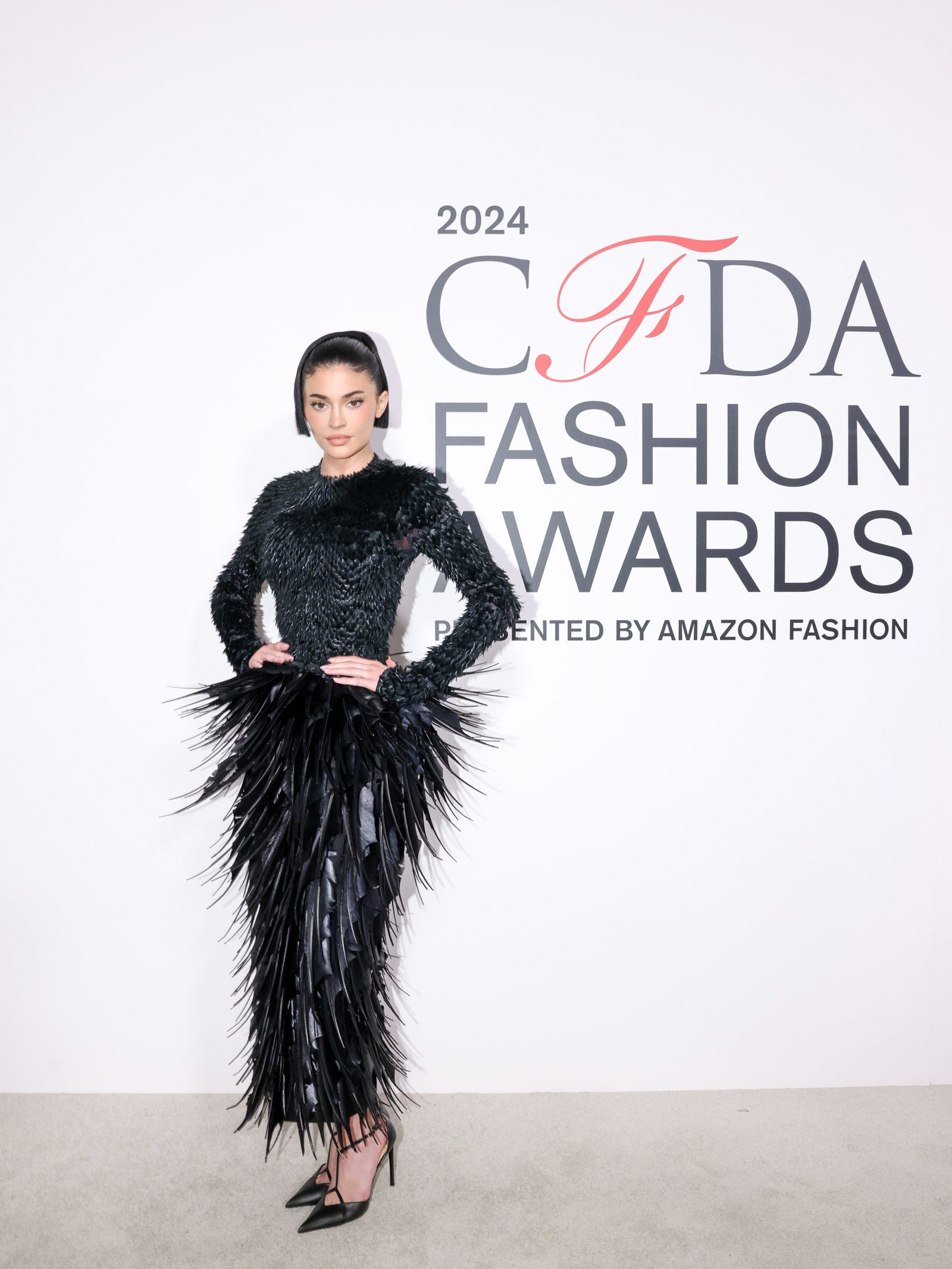 Kylie Jenner commands attention in a Jean Paul Gaultier Spring-Summer 2023 sculptural dress, embodying the evening's celebration of avant-garde American design. (Image: BFA)