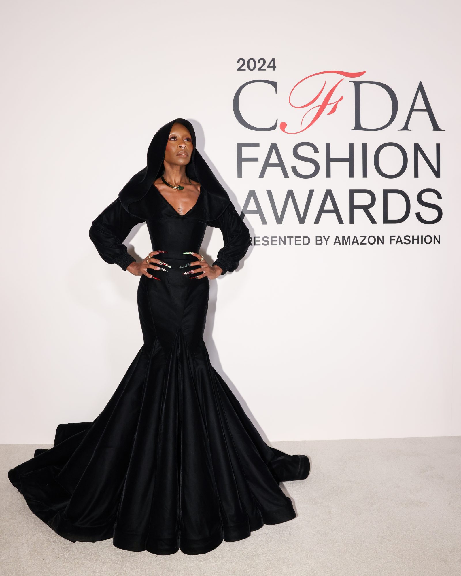 Cynthia Erivo exemplifies modern elegance in a custom Zac Posen for Gap creation, the hooded black gown marking a triumphant fusion of luxury and accessibility. (Image: BFA)