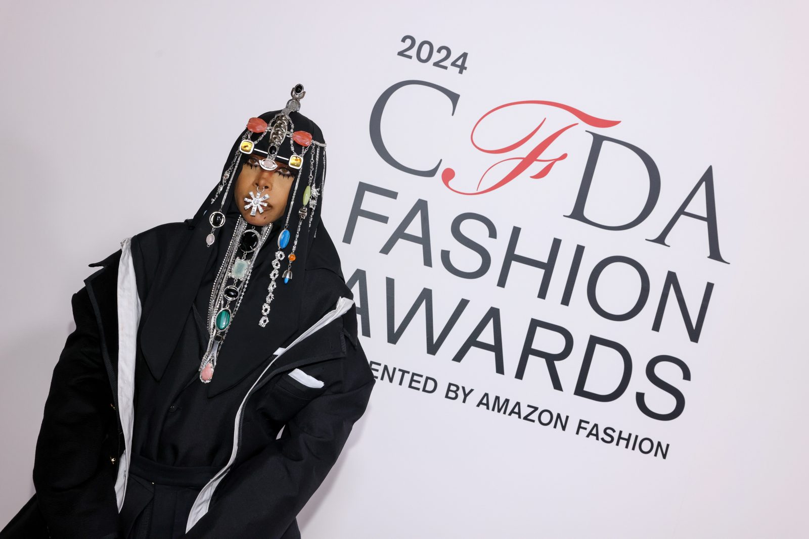 Fashion Icon recipient Erykah Badu showcases Thom Browne's masterful tailoring in a Chesterfield-inspired ensemble, complete with her signature elevated headpiece. (Image: BFA)