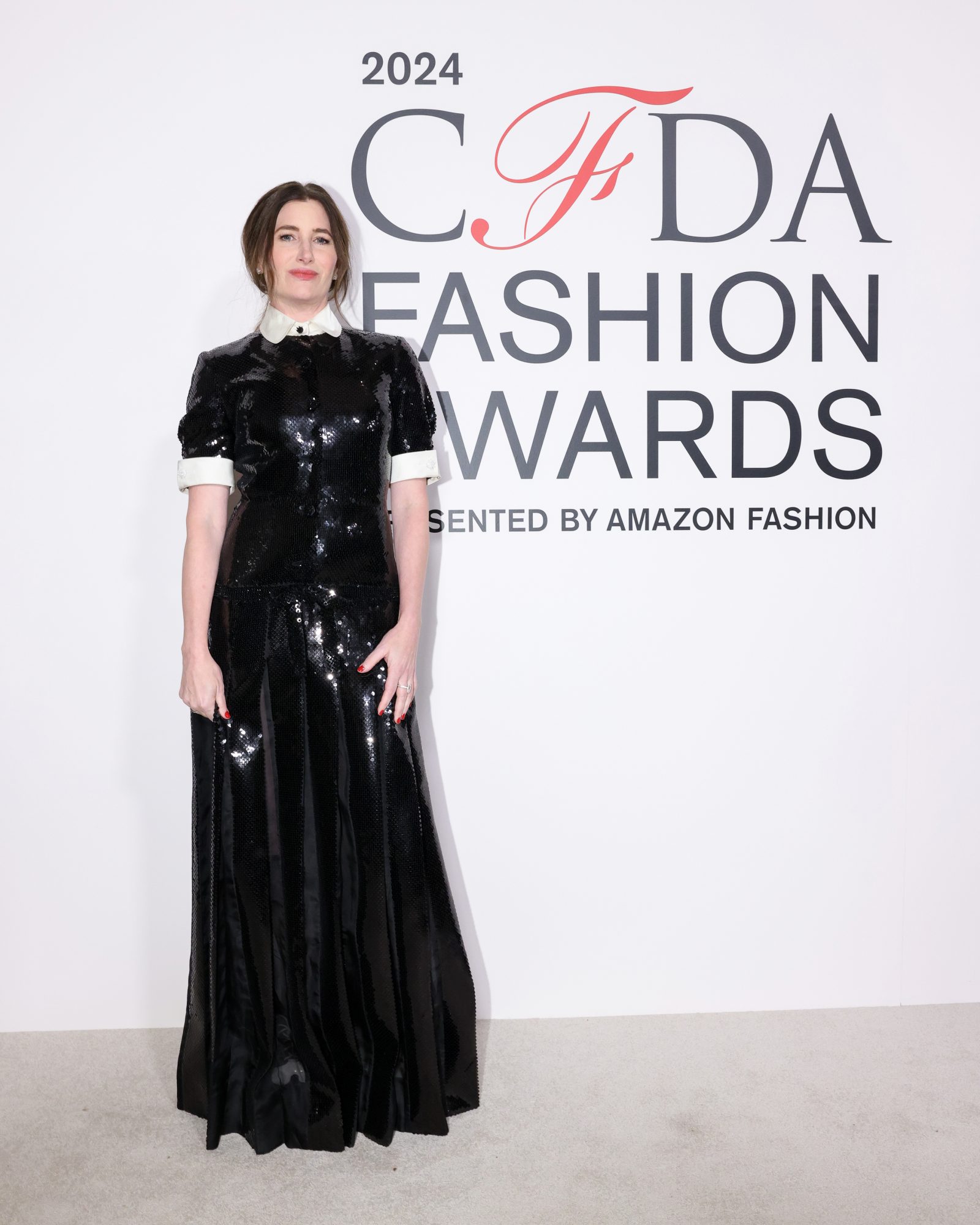 Kathryn Hahn demonstrates the versatility of Thom Browne's vision in a precisely tailored ensemble that marries traditional suiting with contemporary edge. (Image: BFA)