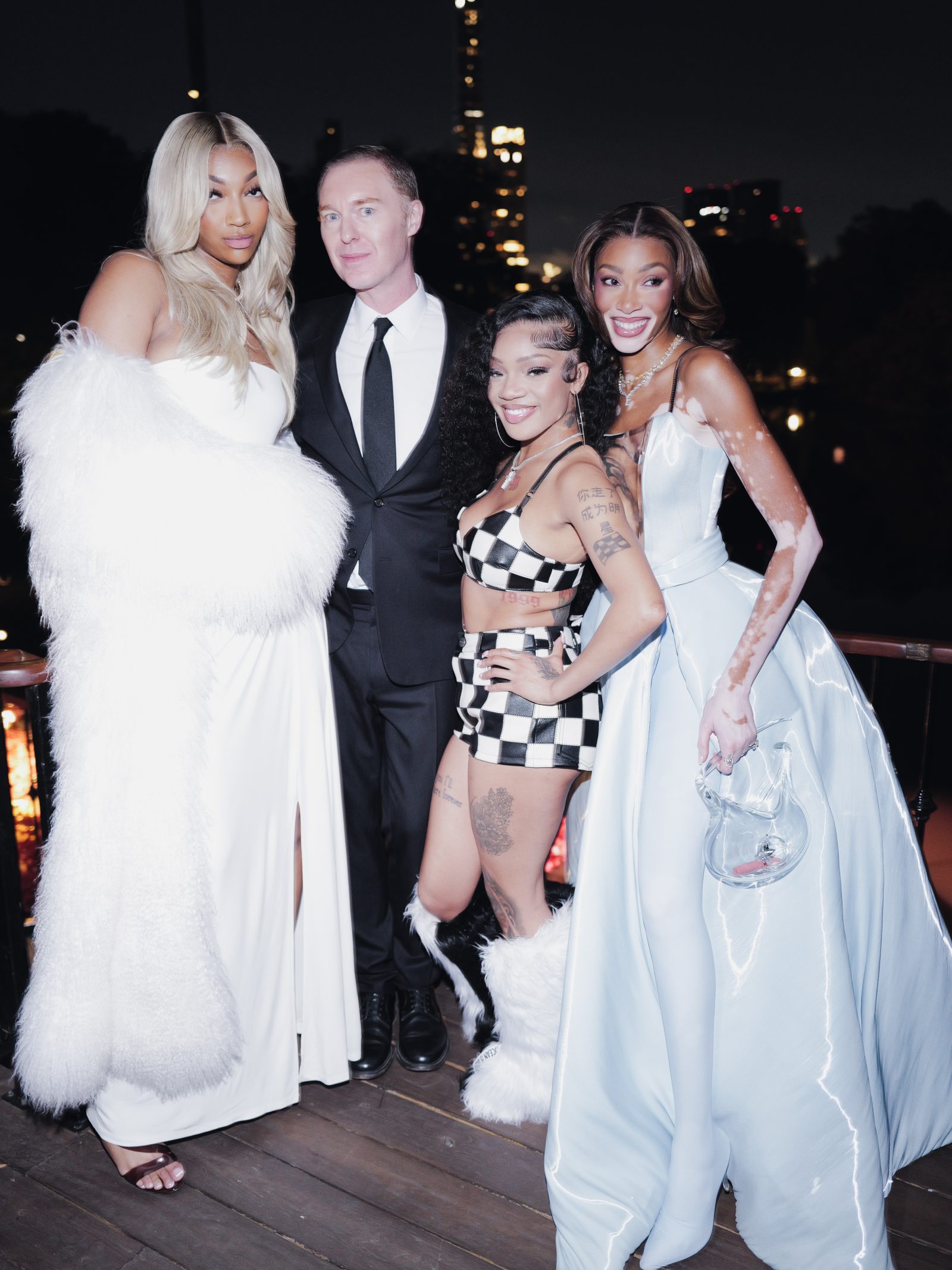 Basketball phenomenon Angel Reese, Coach Creative Director Stuart Vevers, rapper GloRilla, and supermodel Winnie Harlow celebrate at the Central Park Boathouse afterparty. (Image: BFA)