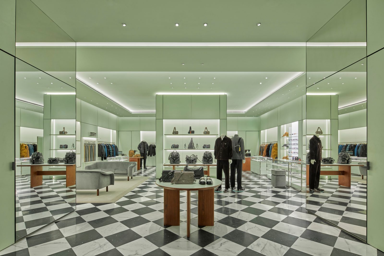 The sublime space features illuminated display walls and geometric fixtures that showcase the latest men's and women's collections. (Photo: Courtesy of Prada)