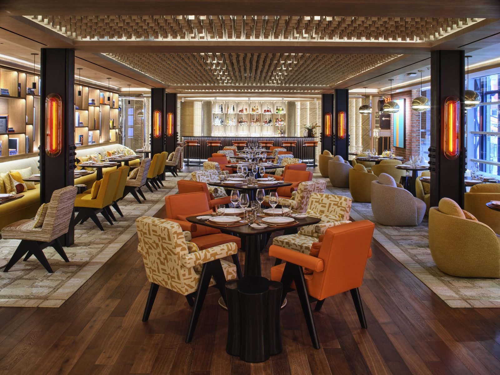 Le Café Louis Vuitton's 70-seat dining area combines warm woods, geometric lighting, and Monogram-patterned upholstery to create an intimate luxury dining experience.