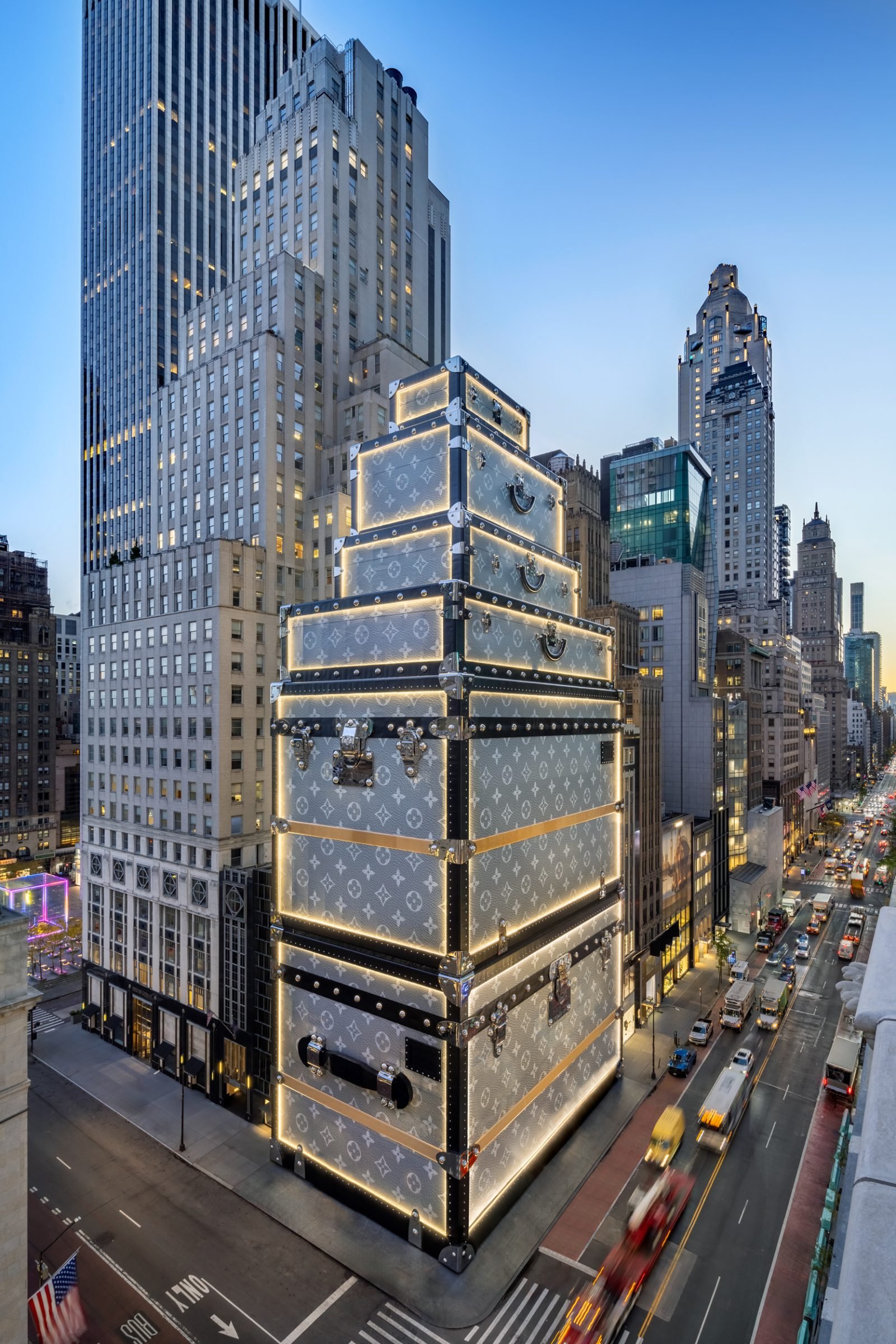 The monumental trunk installation lights up Fifth Avenue at dusk, creating a new architectural landmark that stands tall above New York's bustling streets.
