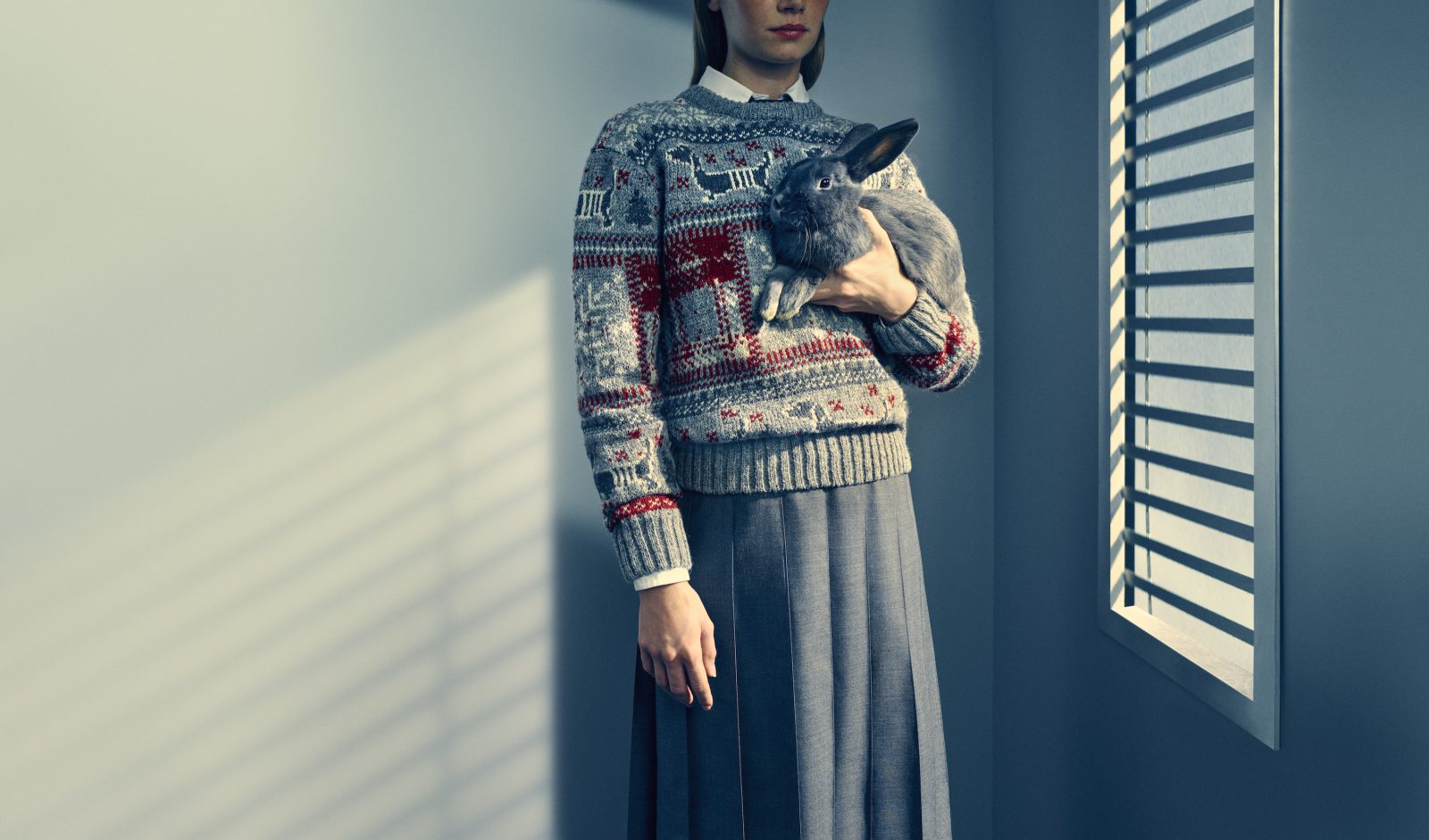 A Hector Pullover sweater takes center stage, accompanied by a charming grey rabbit—an imaginative addition to Browne’s playful holiday vision. (Image: Courtesy of Thom Browne)
