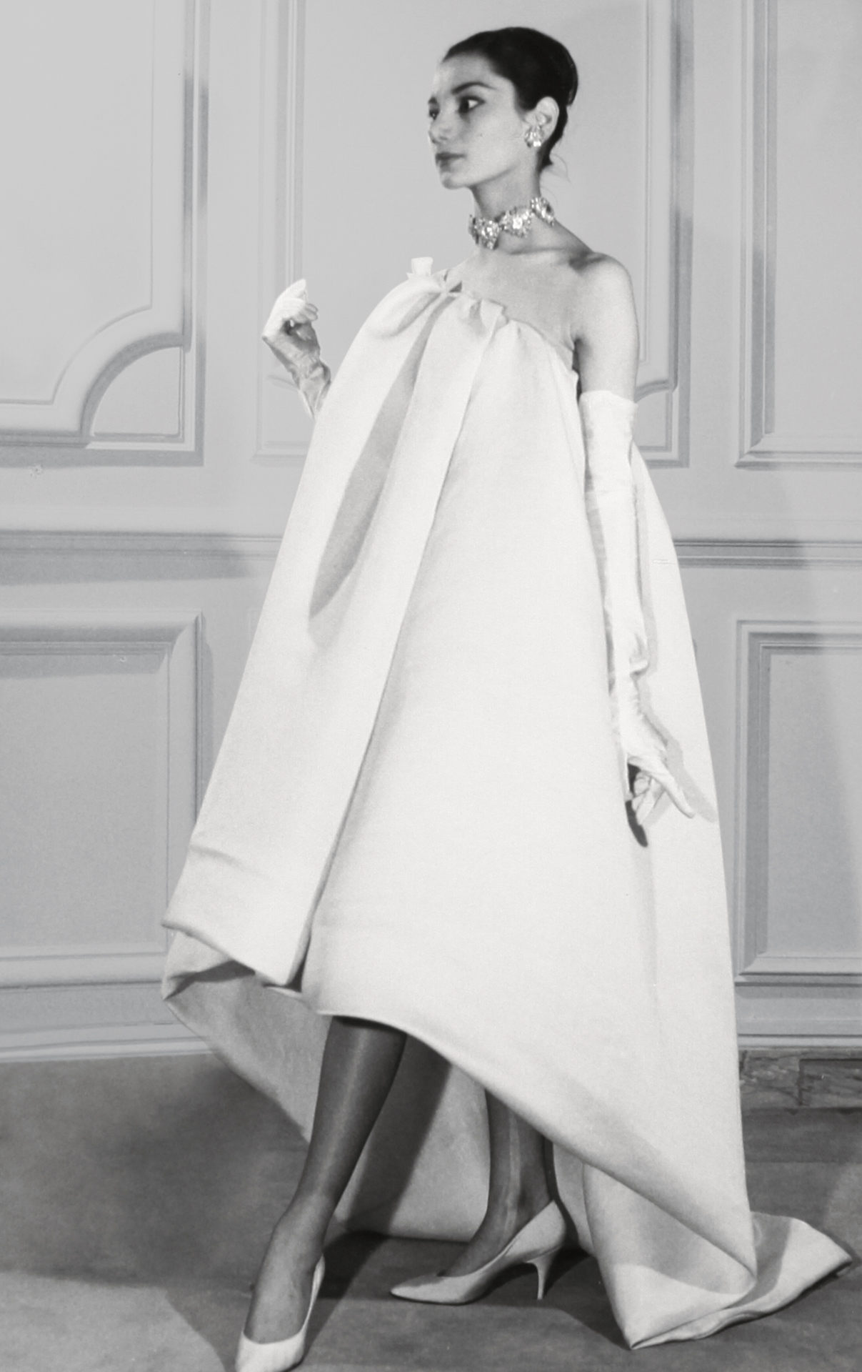 Iconic Elegance: A photographic print from the Spring-Summer 1959 Haute Couture collection by Hubert de Givenchy, capturing the timeless allure and classic sophistication of the House's early days.